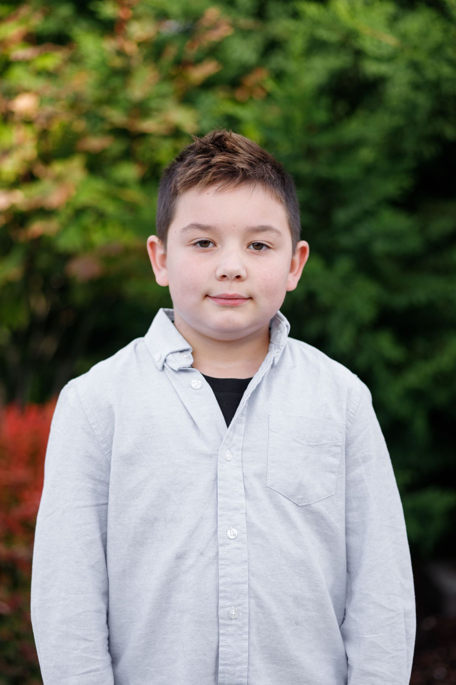 Multiple portrait shots showing a light gray button-up shirt against natural foliage background.
