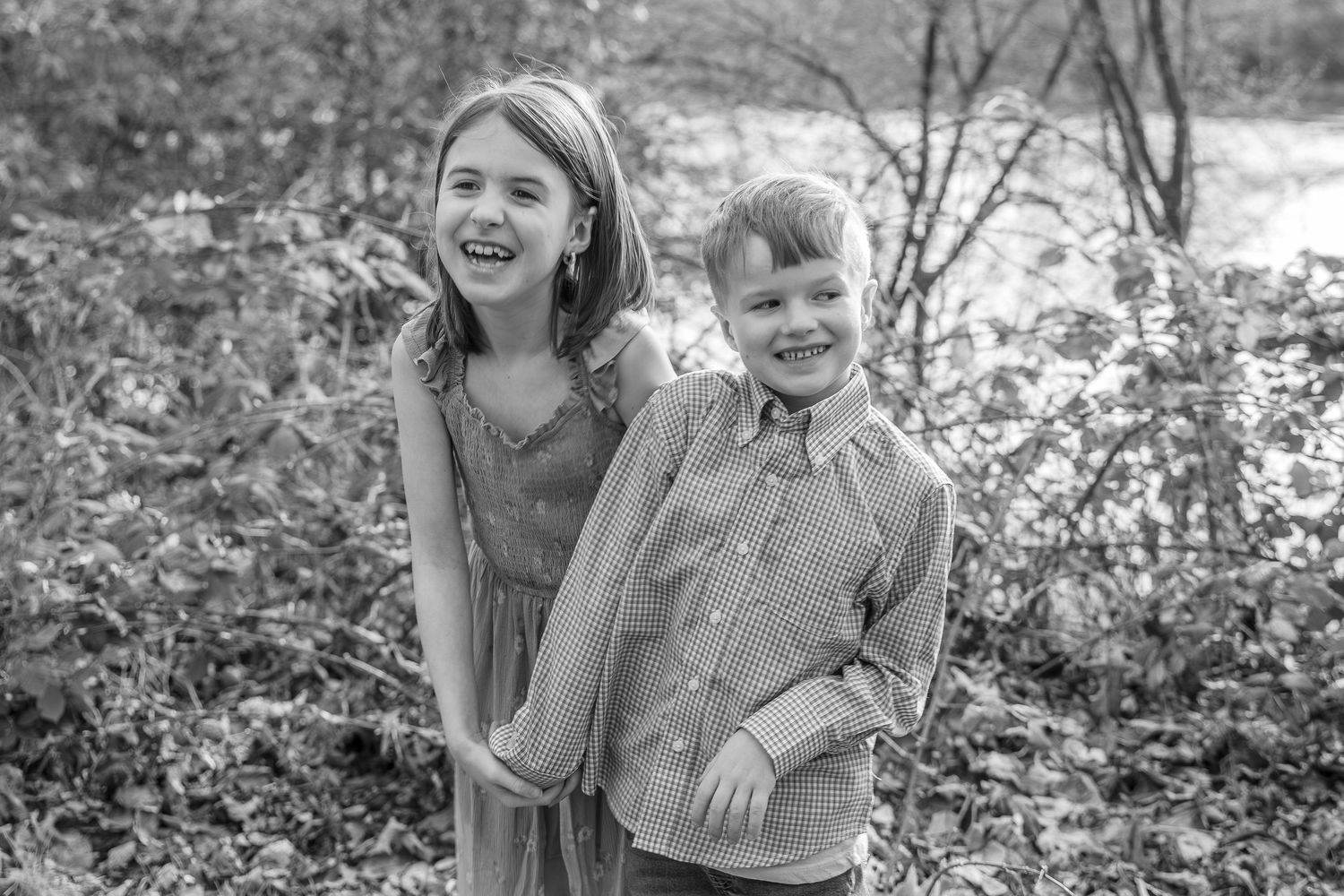 Black and white family photos arranged in a collage showing candid outdoor moments in nature.