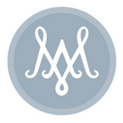 Elegant monogram logo featuring interlaced M letters in white against a light blue circular background.