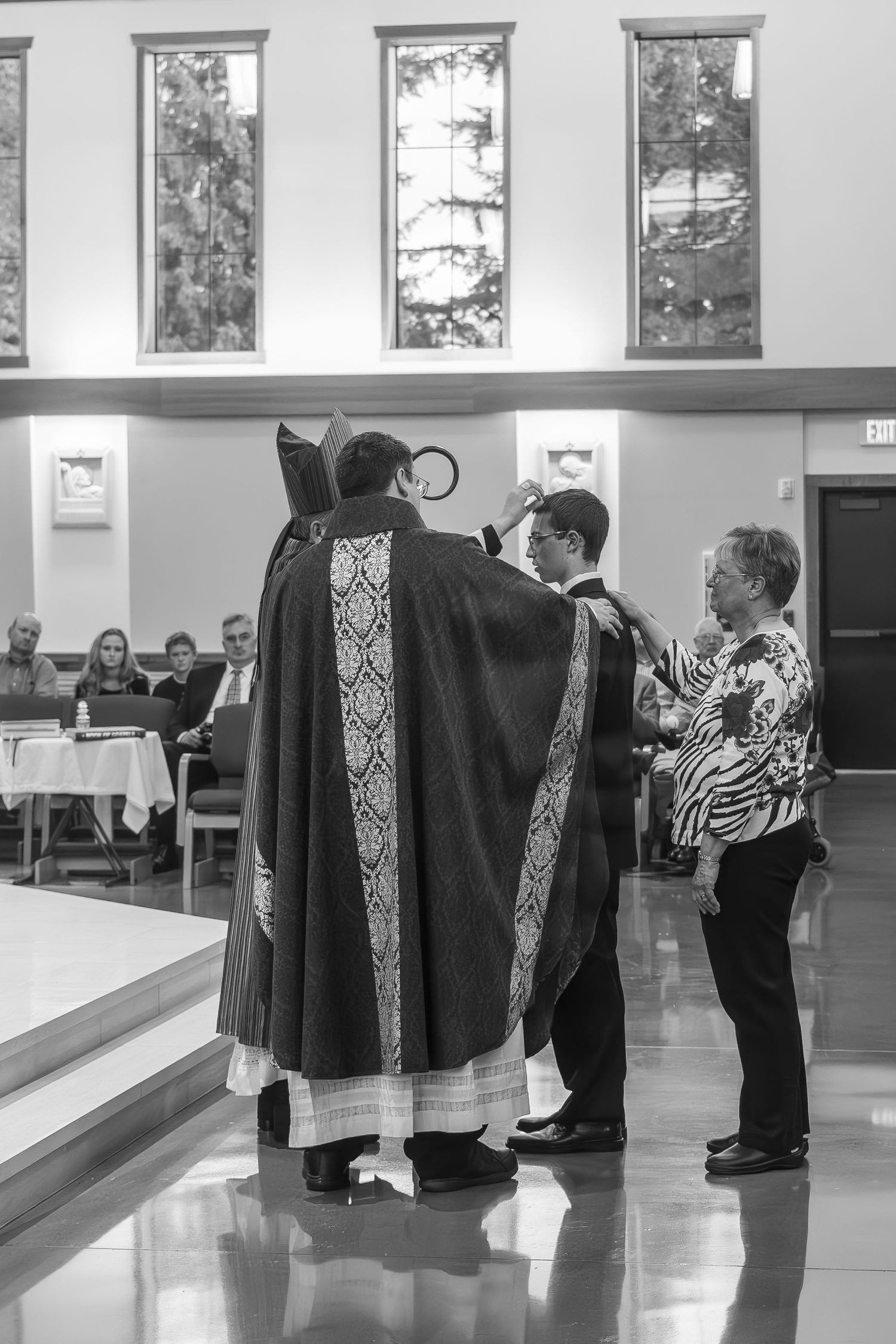 Religious clergy members gather in traditional robes during a church service ceremony.