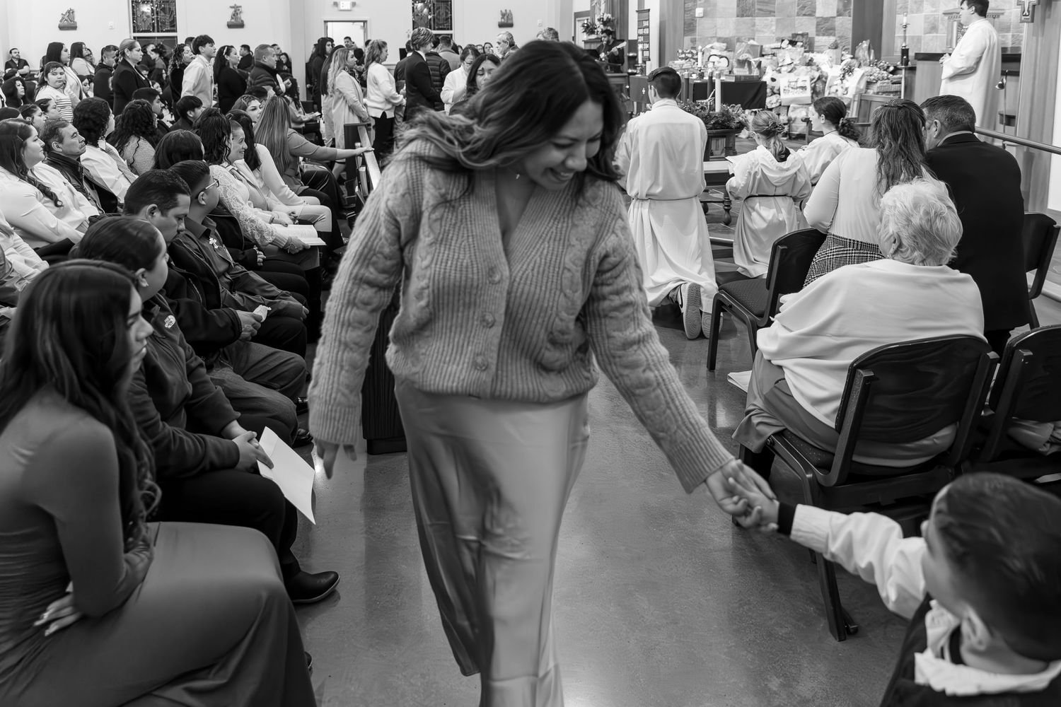 Vintage black and white photograph showing a crowded waiting room scene in what appears to be a medical office or clinic.
