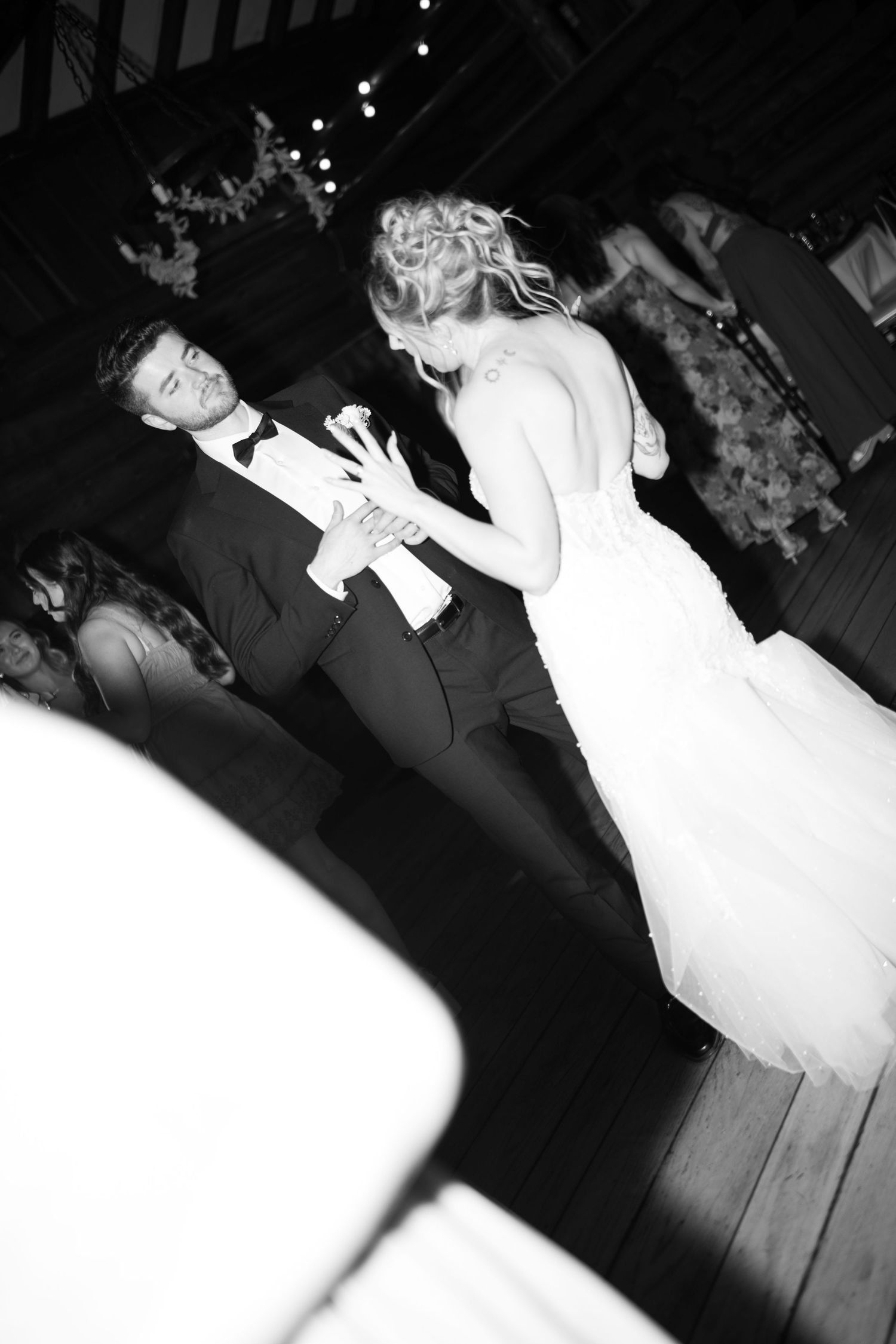 Romantic black and white sequence of newlyweds dancing at their wedding reception in flowing motion.