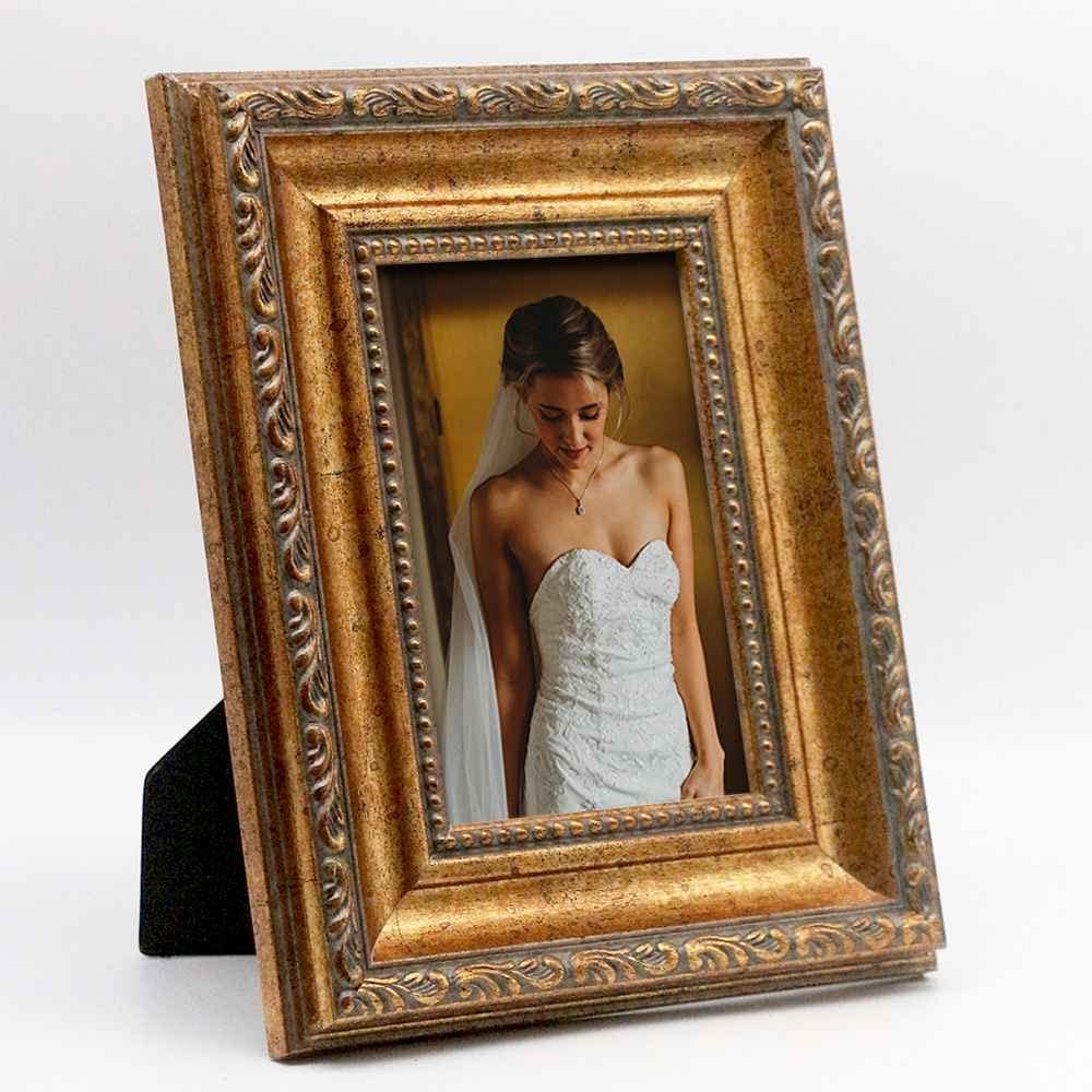 Four identical ornate gold picture frames arranged in a cascading line on a white background.