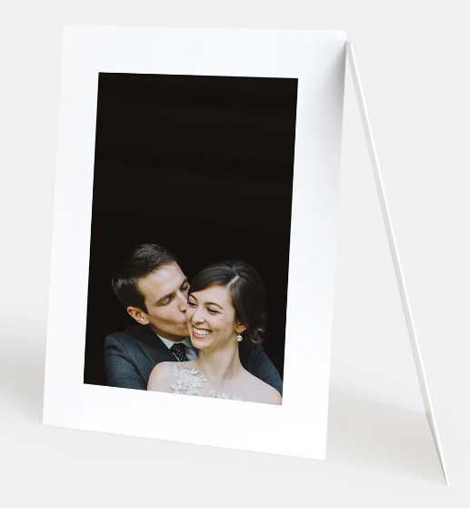 Romantic black and white polaroid-style photographs showing tender moments between a couple.