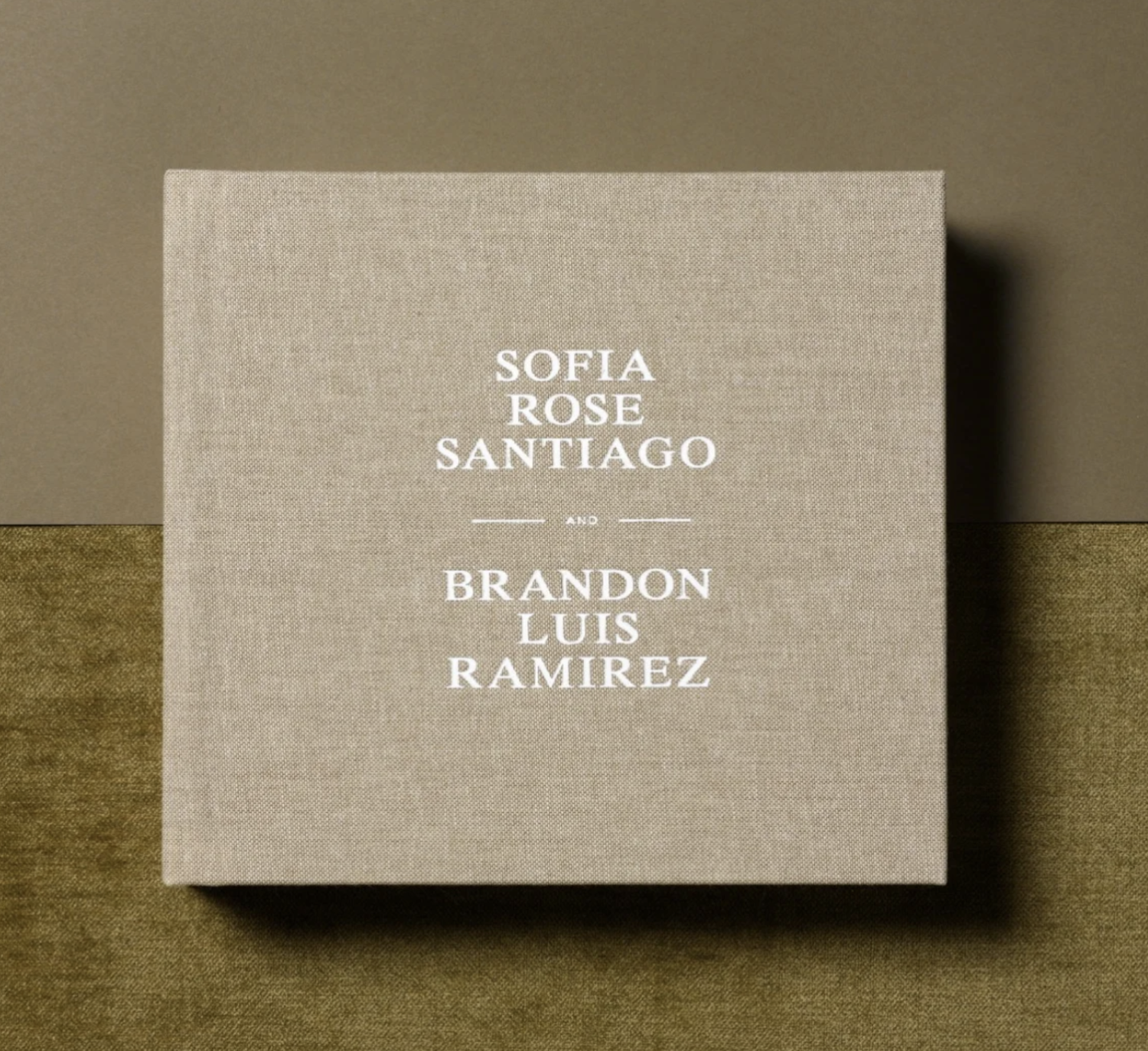 A row of minimalist beige business cards with white text displaying names against a textured background.
