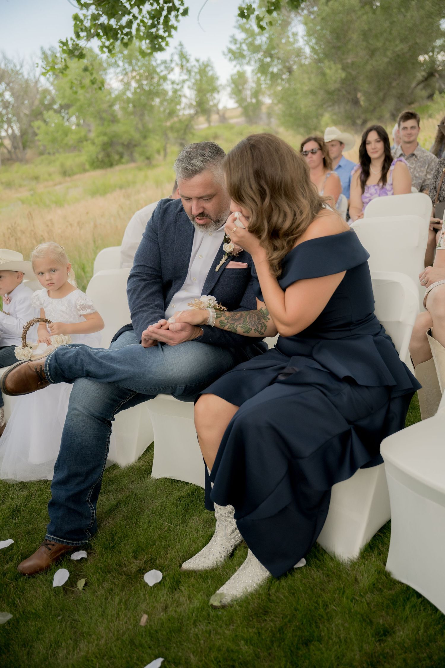 A sequence of emotional candid moments showing people sitting on white chairs during an outdoor event.