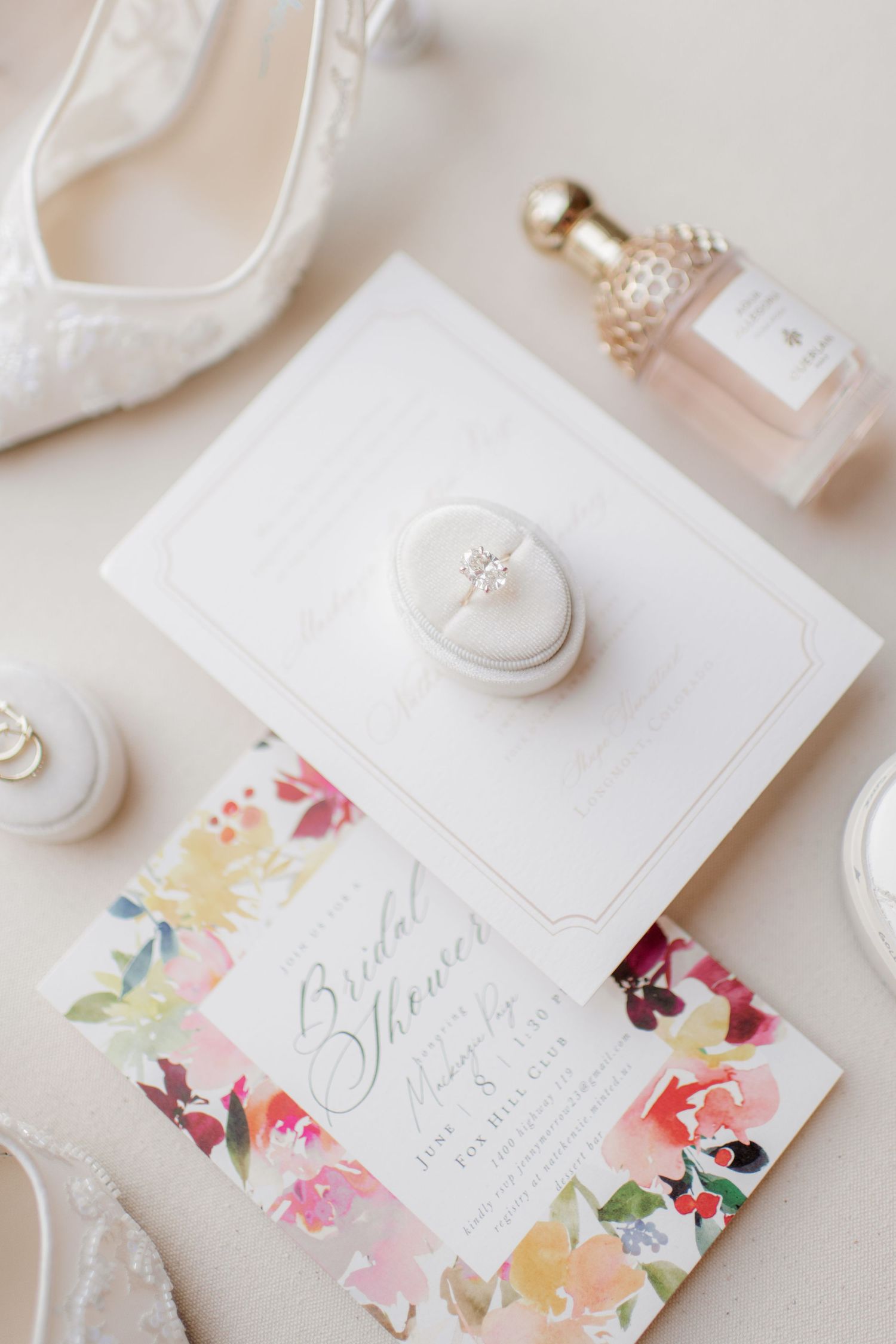 Delicate wedding stationery featuring elegant calligraphy and soft watercolor floral designs on white paper.