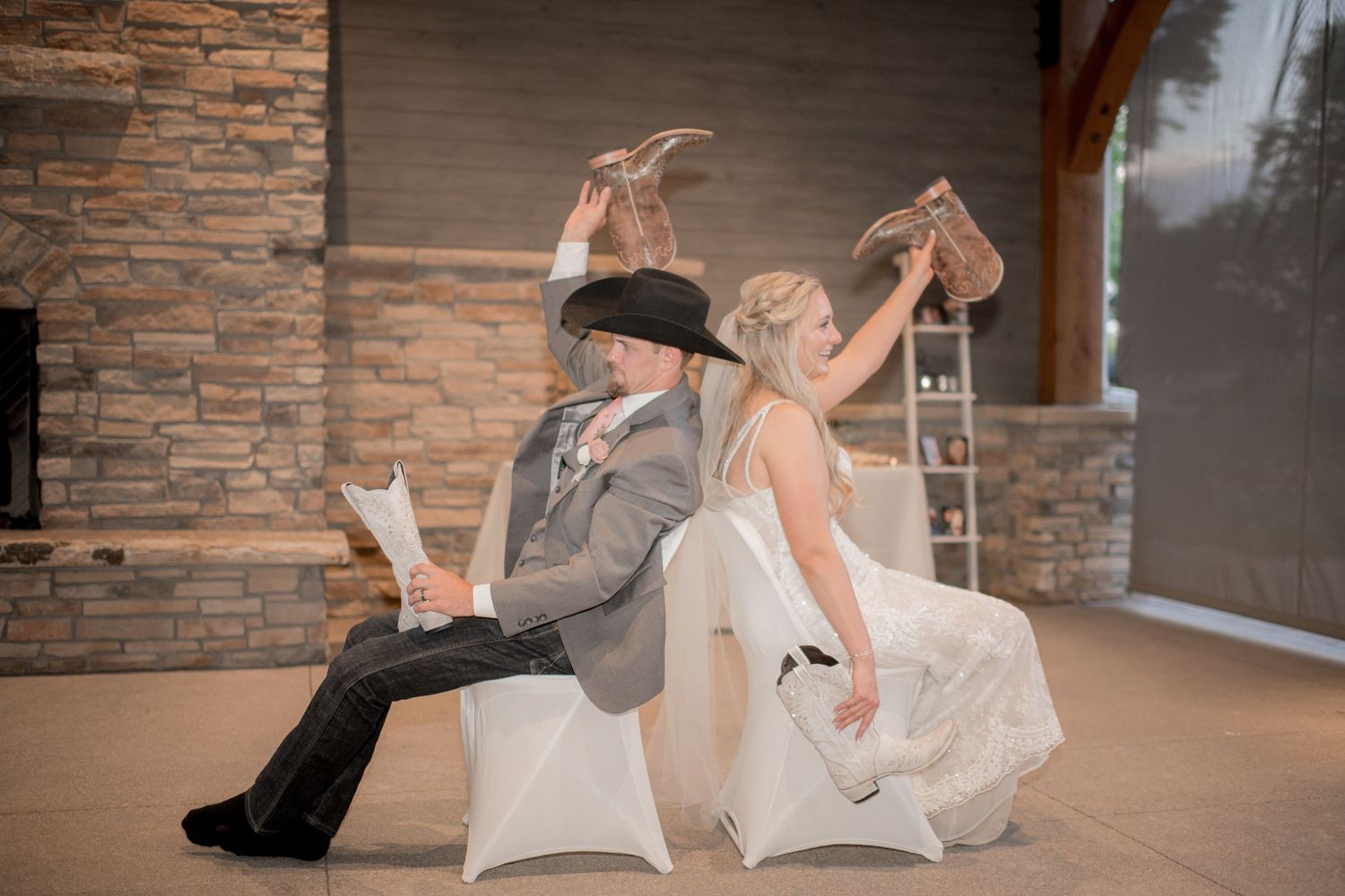 A couple performs a dramatic dance lift sequence in front of a brick wall.