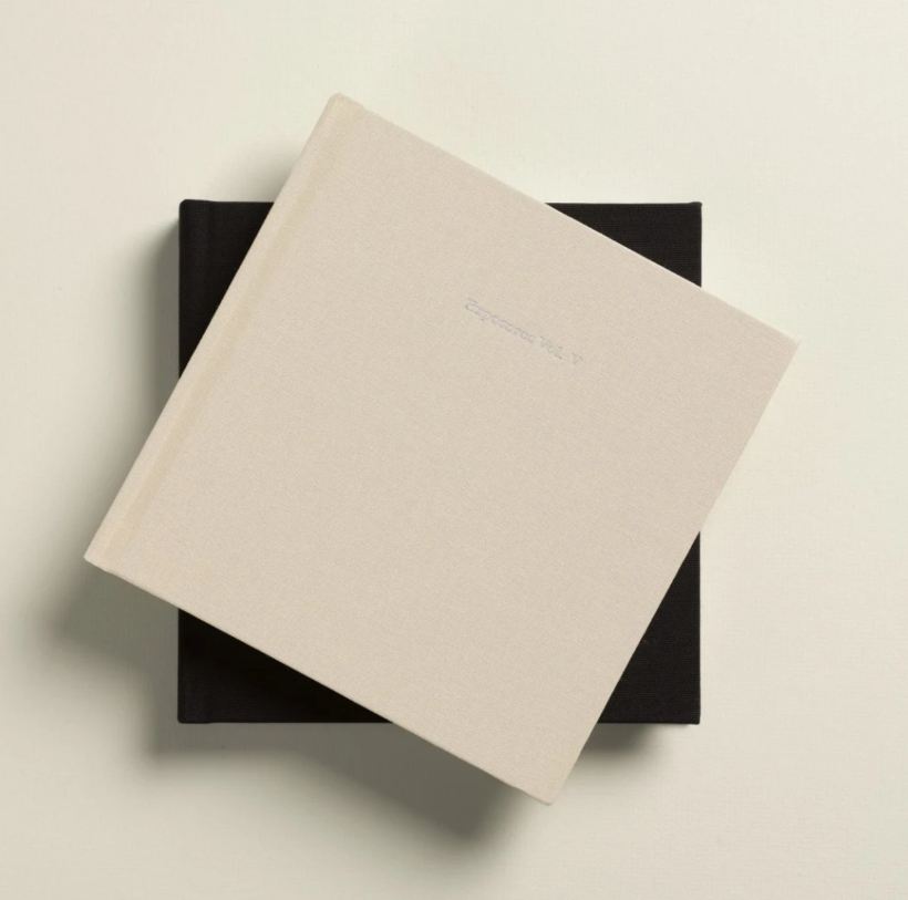 White business card mockup casting shadow on dark surface shown in five different angles and positions.