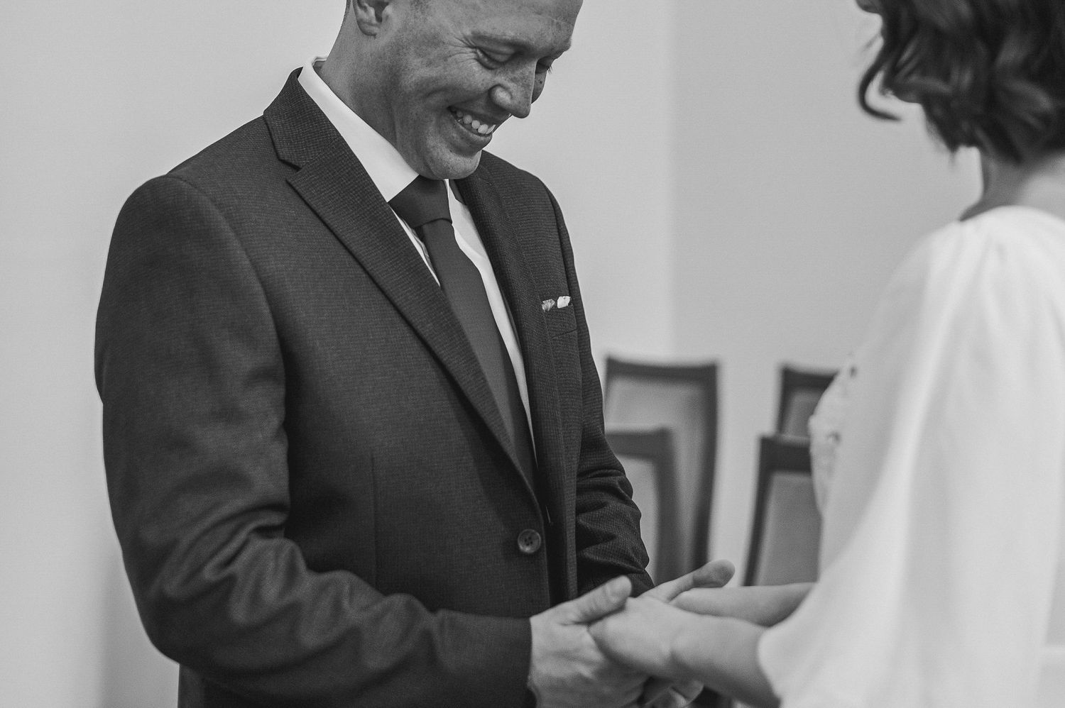 Newlyweds walking hand in hand through a sunlit garden