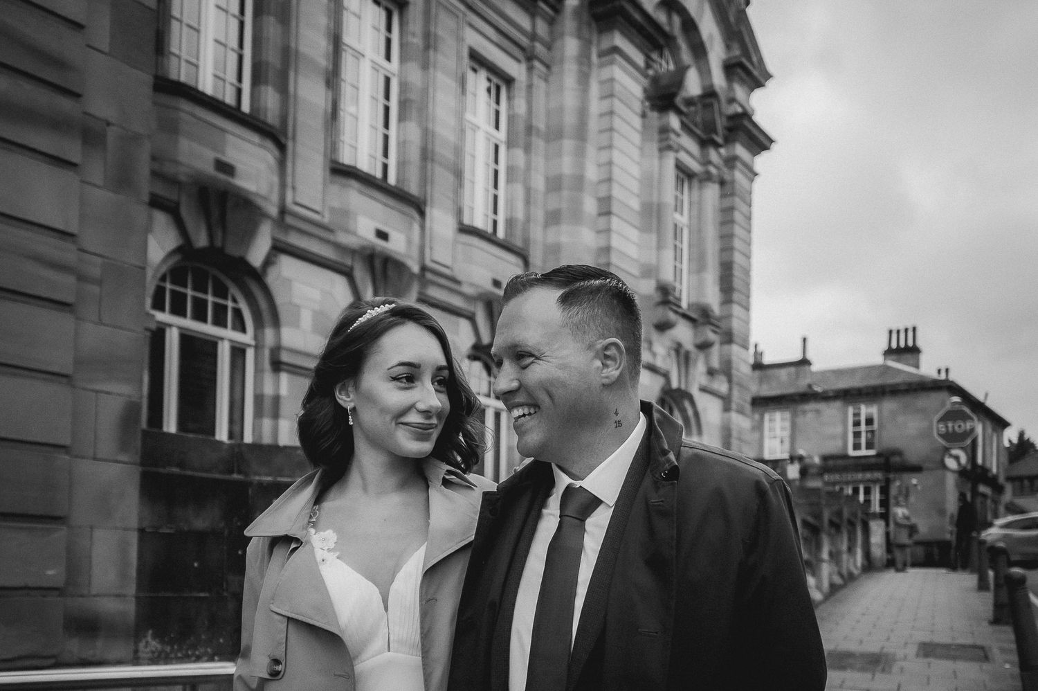 Newlyweds walking hand in hand through a sunlit garden
