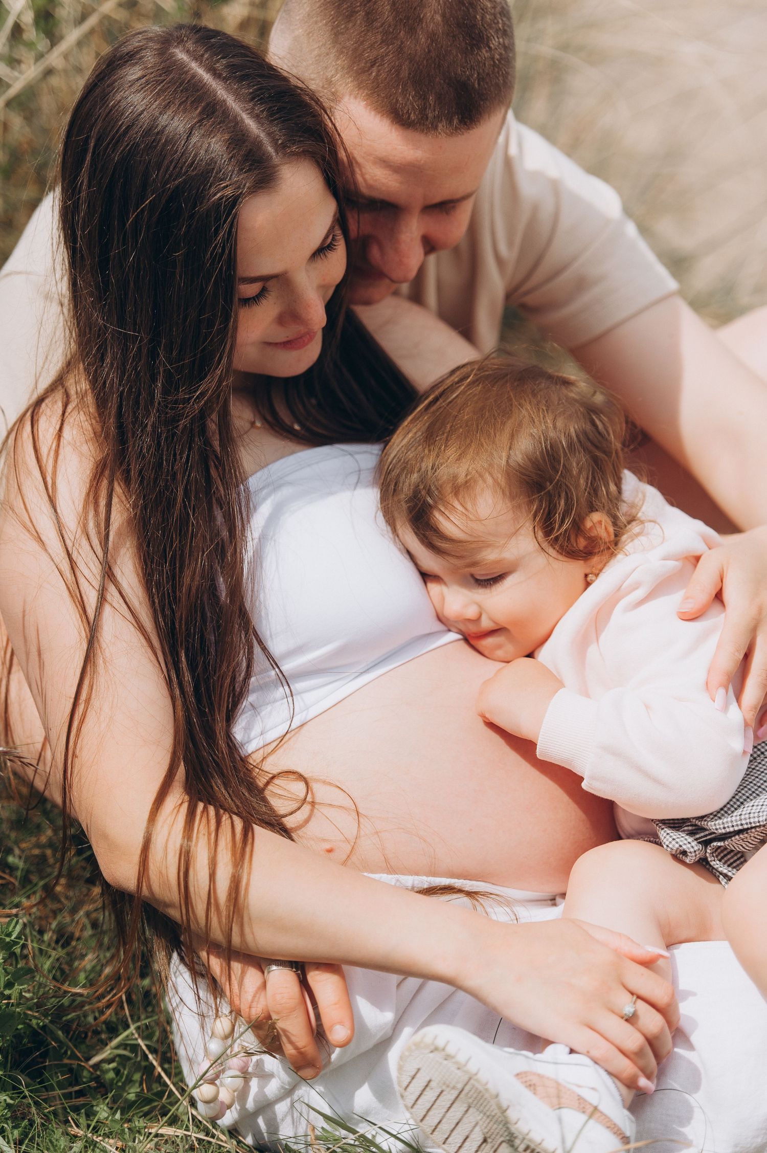 Joyful family photo celebrating the coming of a second child Joyful family photo celebrating the coming of a second child