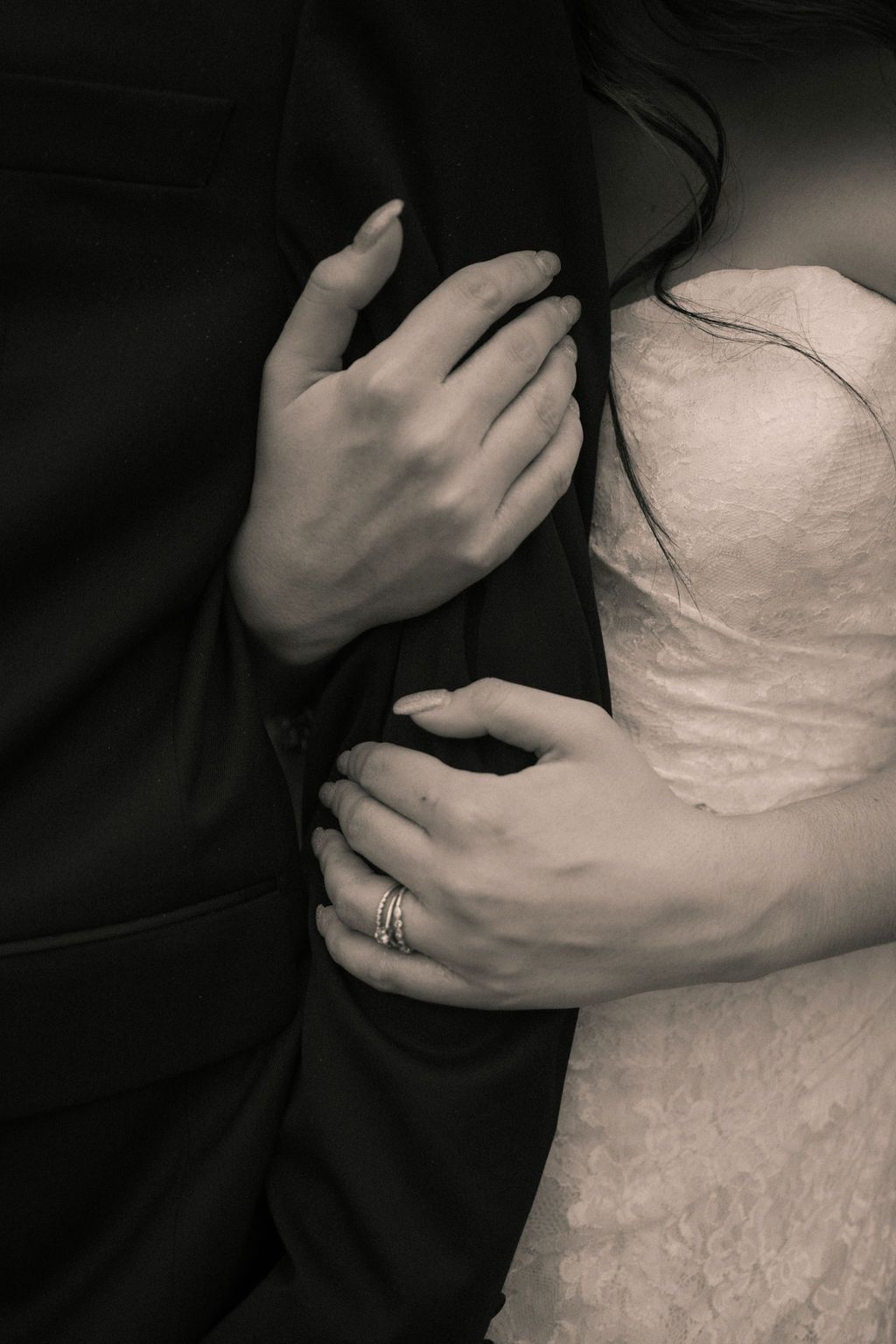 A series of black and white photographs showing hands gently cradling and caressing a white textured surface.