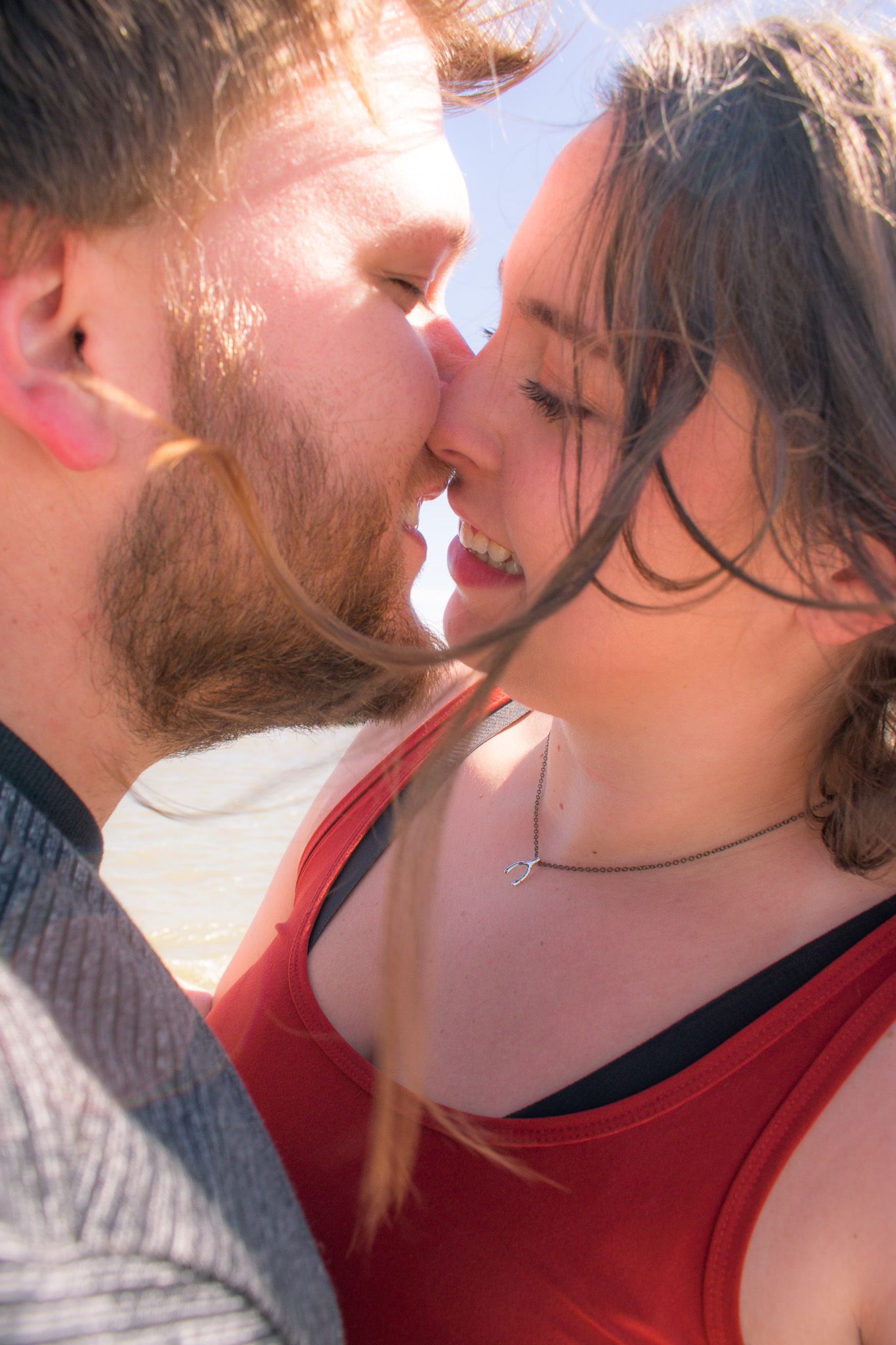 Intimate close-up series of a couple sharing tender moments in sunlight.