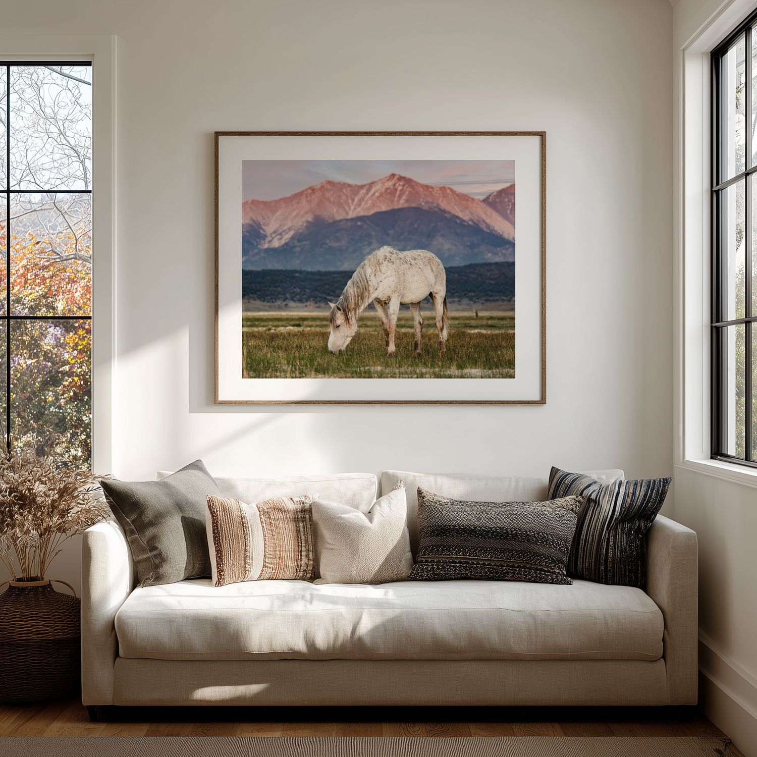 Panoramic series of living room windows with landscape artwork and white modern furniture in natural light.