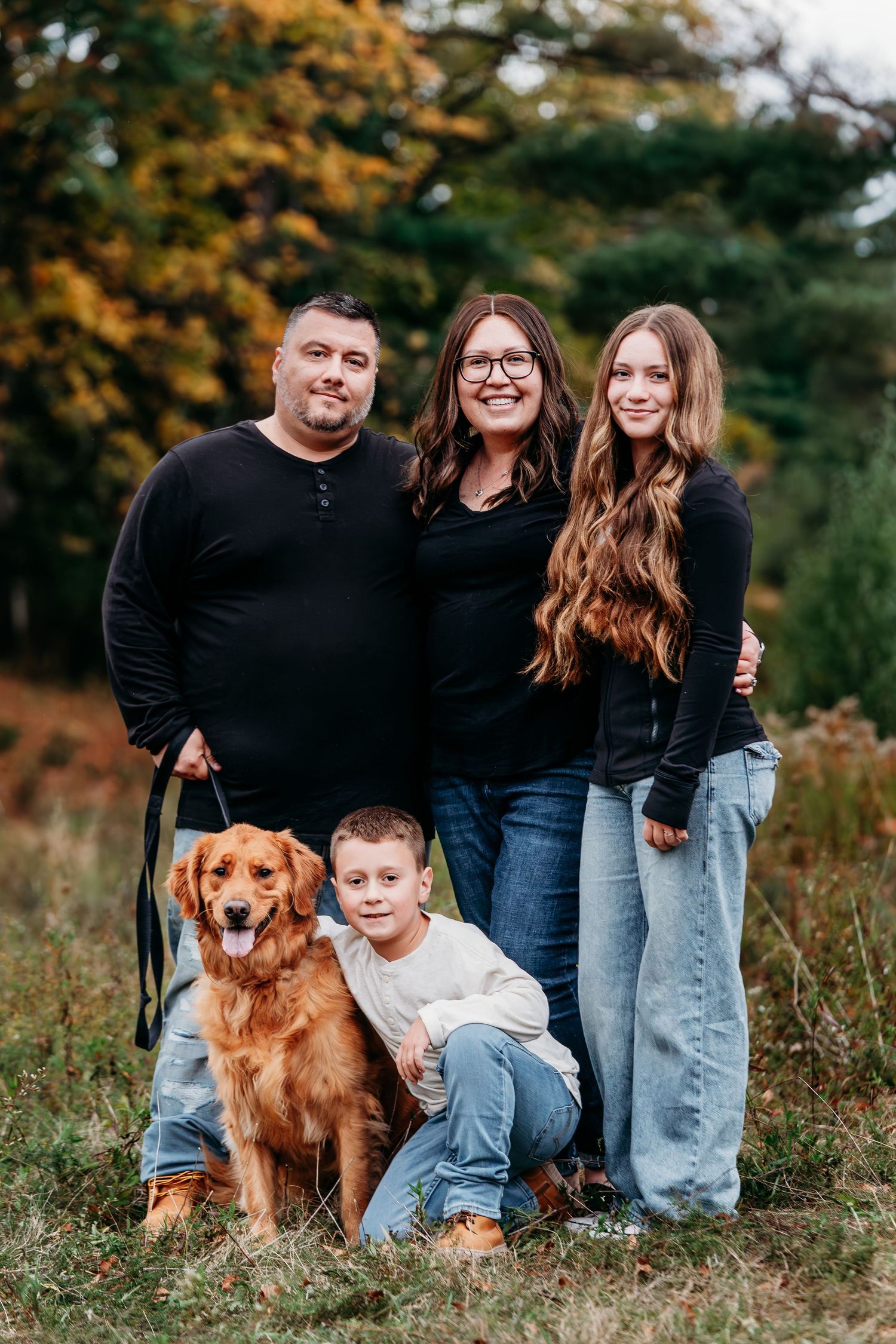 Family portrait series with golden retriever dog in autumn field setting.