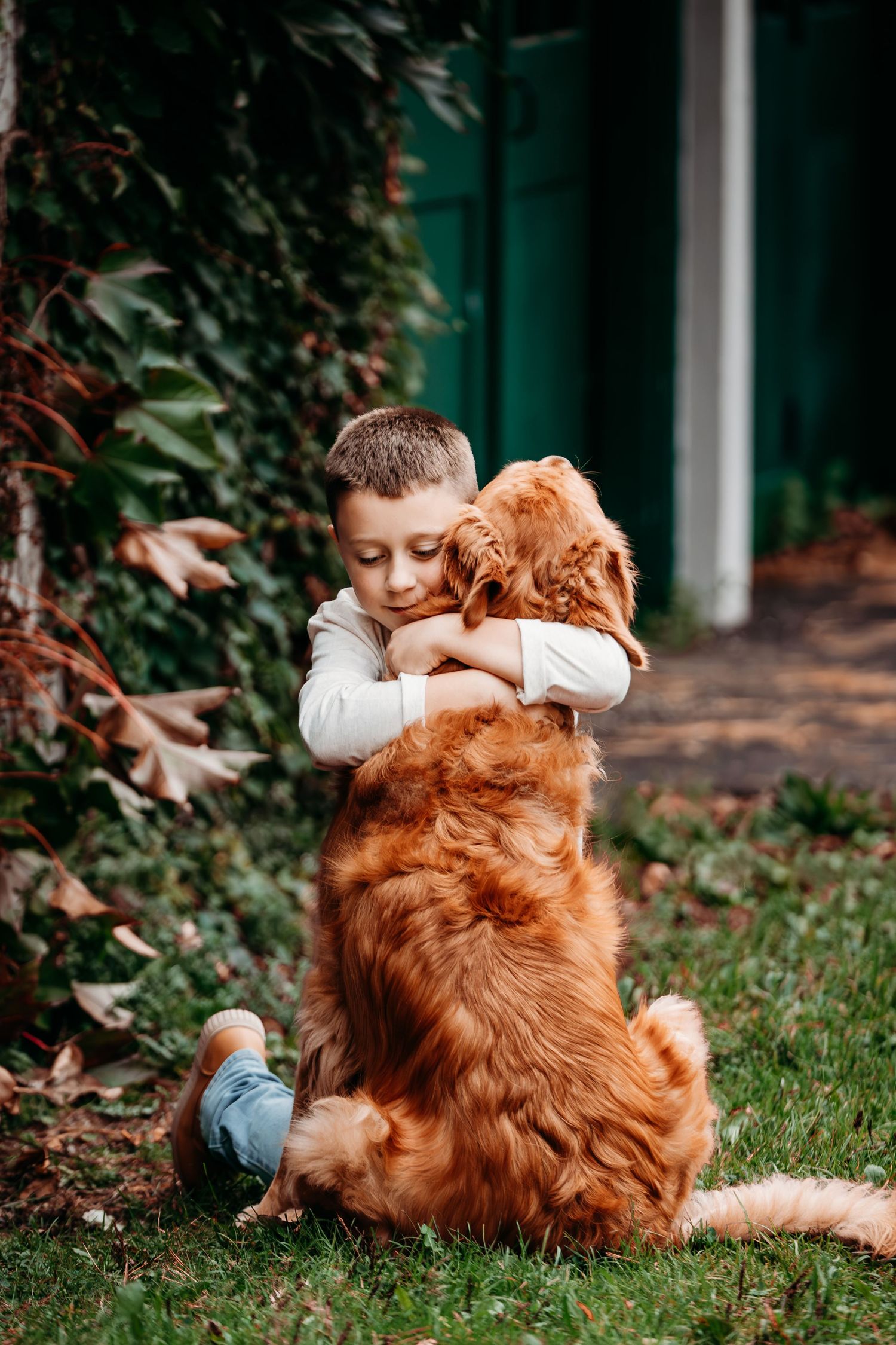 Series showing tender moments between golden retriever and child on grass.