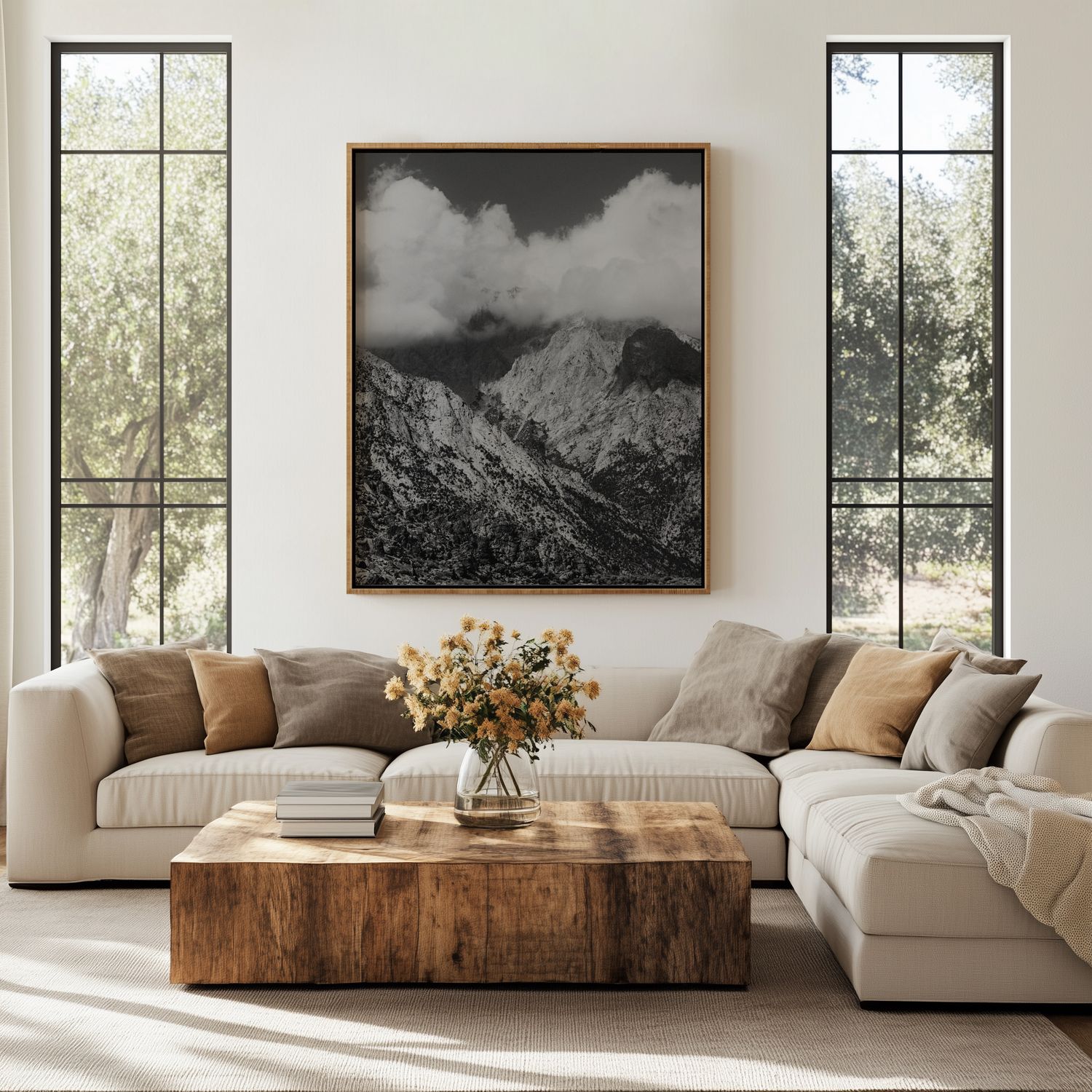 Modern living room with white sectional sofa, wooden coffee table, and black and white landscape art on neutral walls.