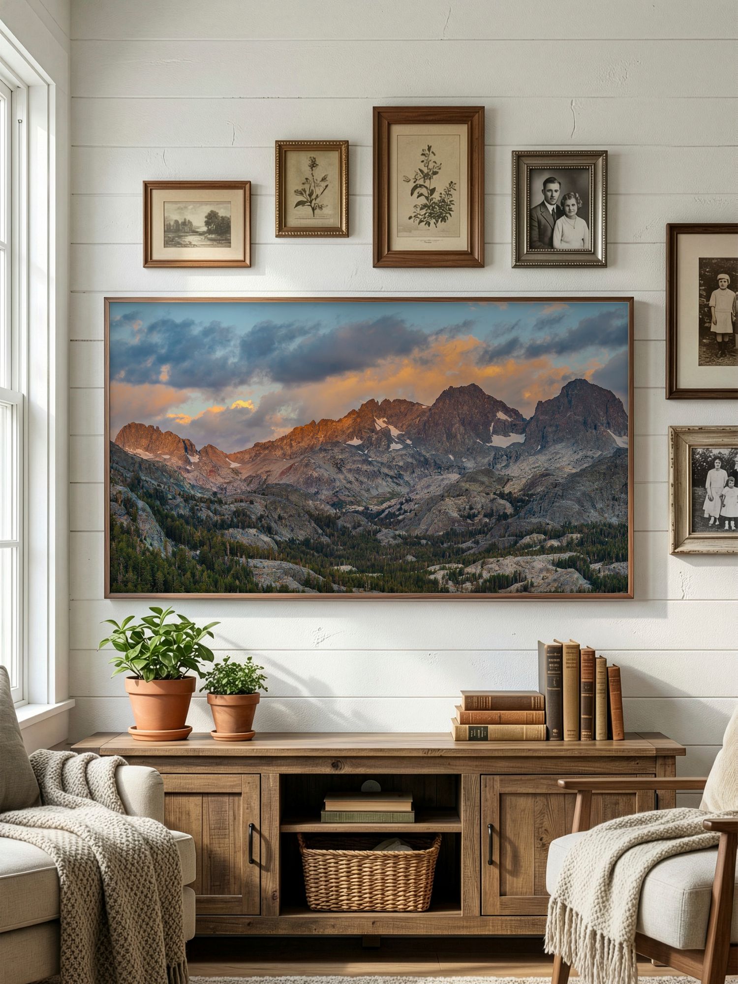 Modern living room with panoramic mountain landscape artwork displayed above wooden console and cozy seating area.