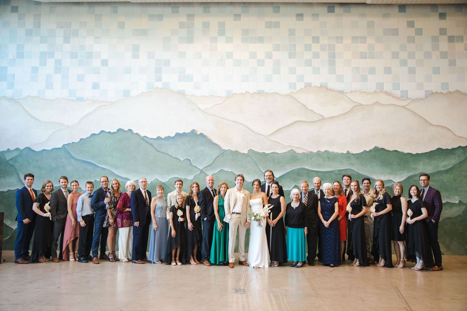 A panoramic series of wedding party photos taken outdoors against a scenic mountain backdrop.