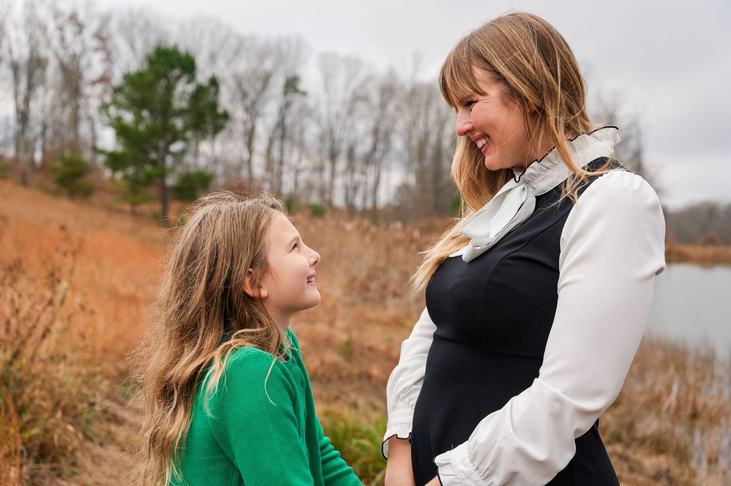 Sweet candid moments captured between family members against winter landscape.