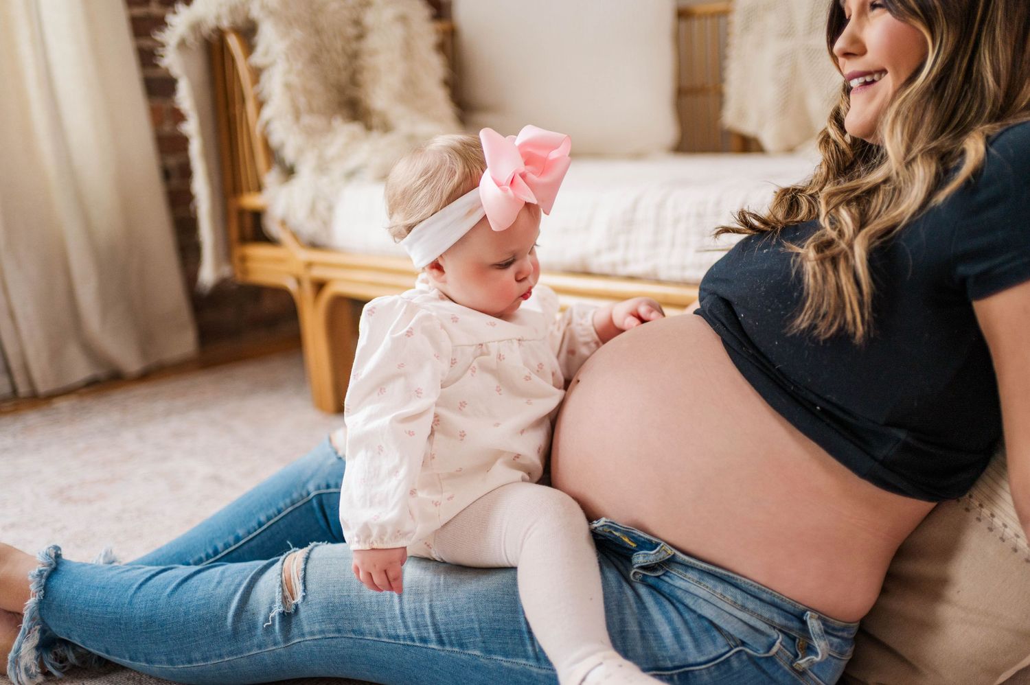 A tender moment between mother and child sitting on the floor in a cozy room.
