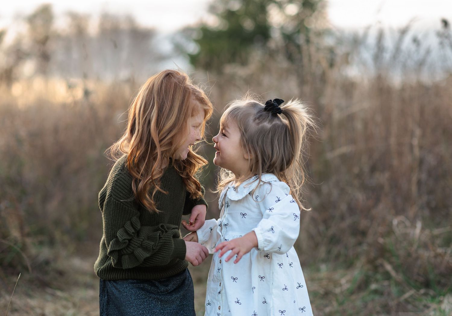 Sweet candid moments between family members in an outdoor setting.
