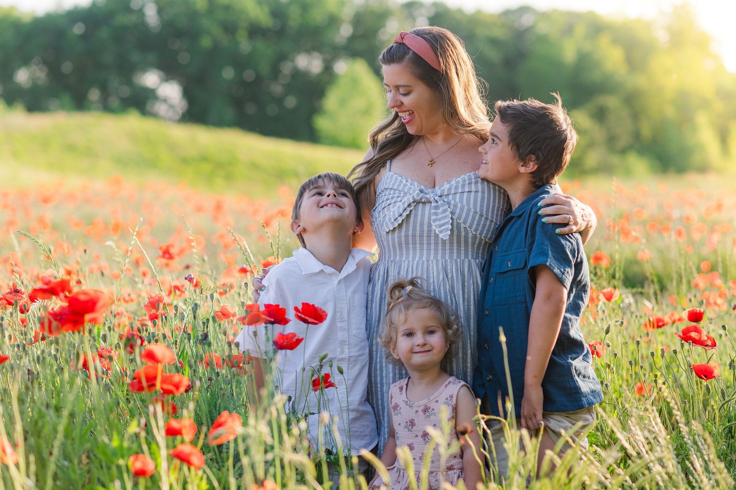 Intimate family moments captured in a wildflower meadow during golden hour.
