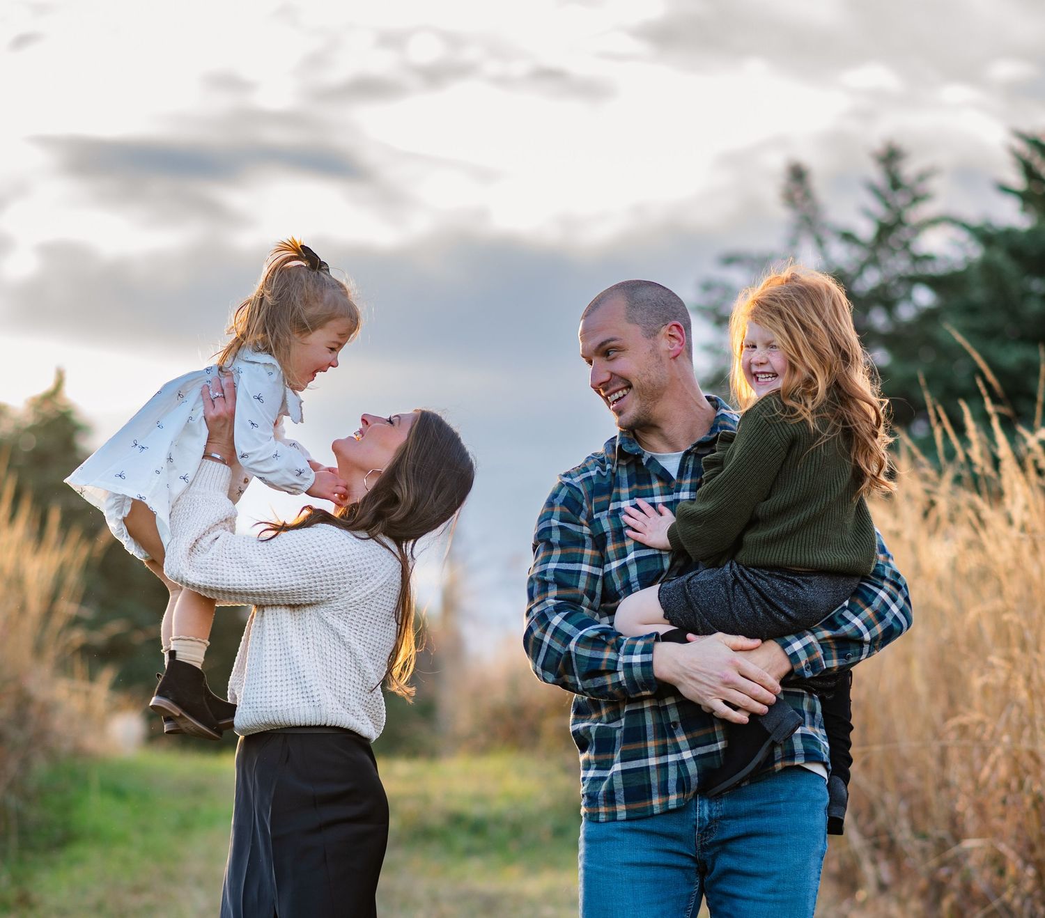 Joyful family interactions and embraces in a natural outdoor setting.