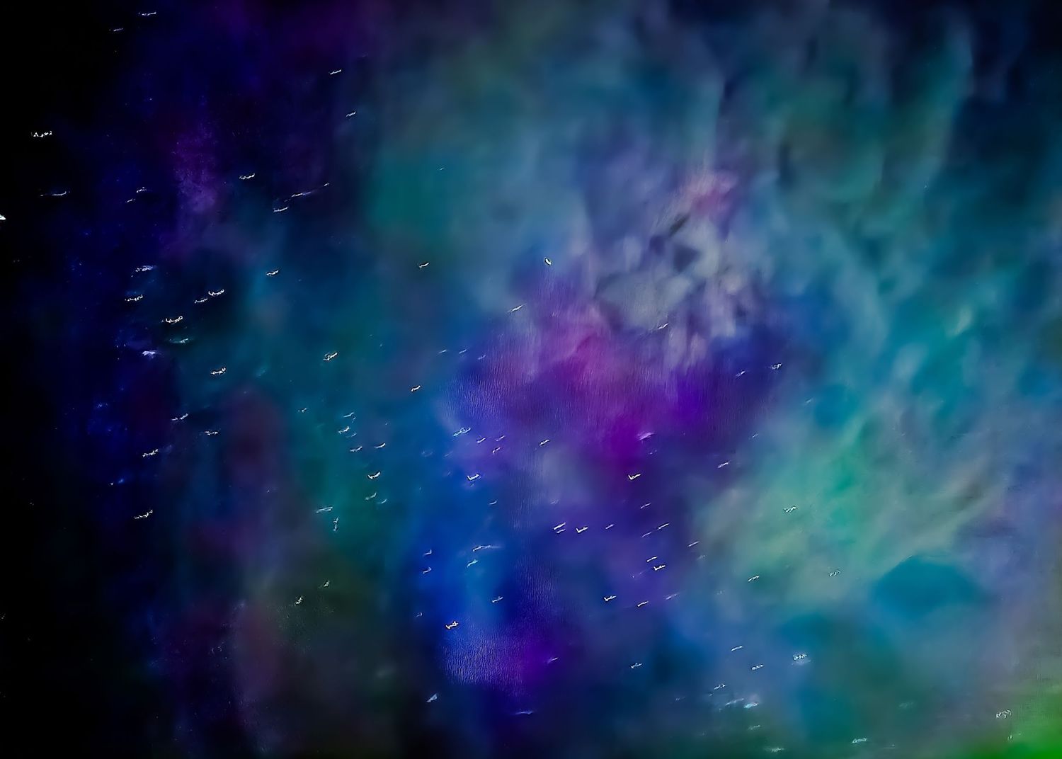 Vibrant aurora borealis display with swirling blue and purple colors against a dark night sky.
