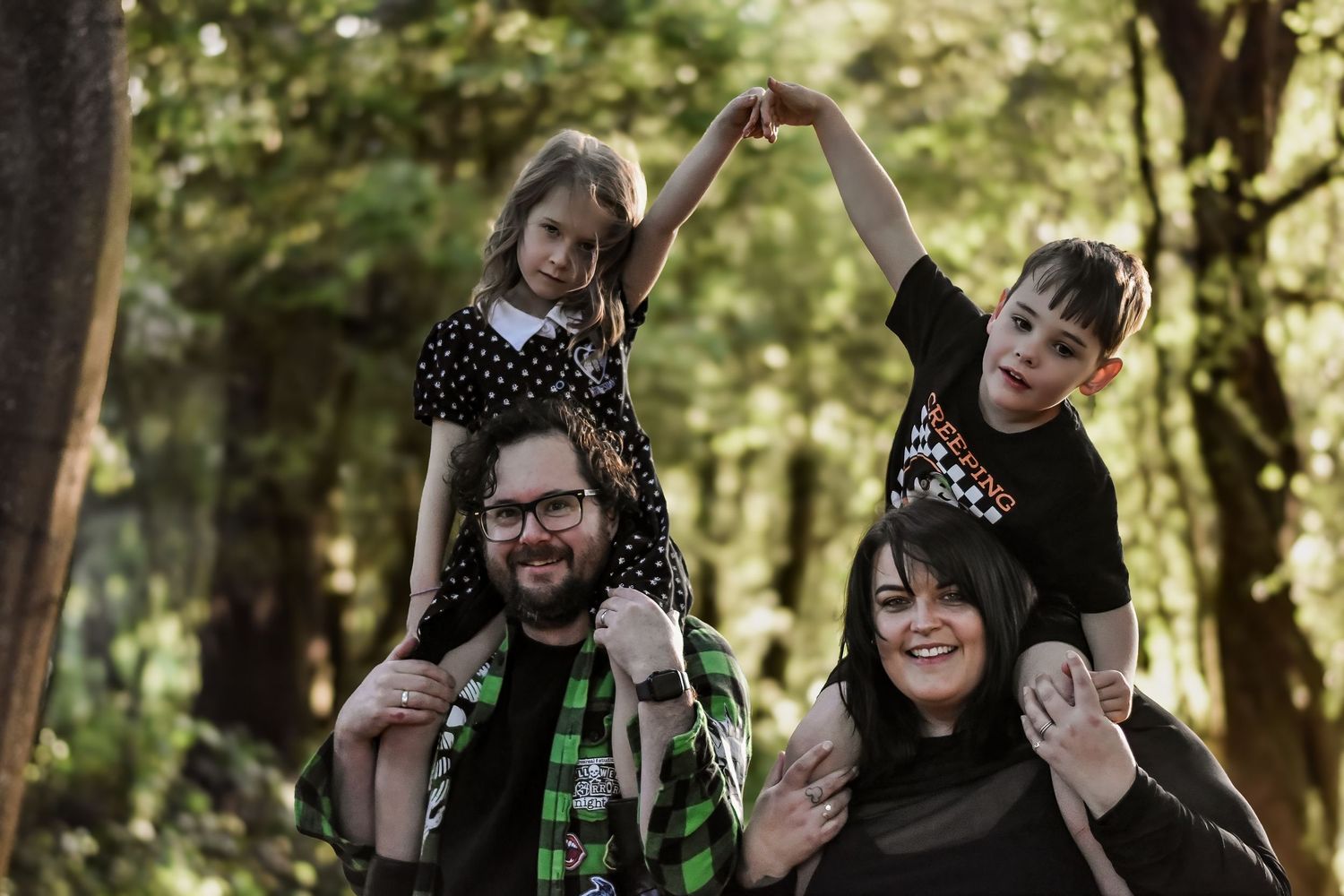 Candid moments of a group laughing and having fun in a forest setting.
