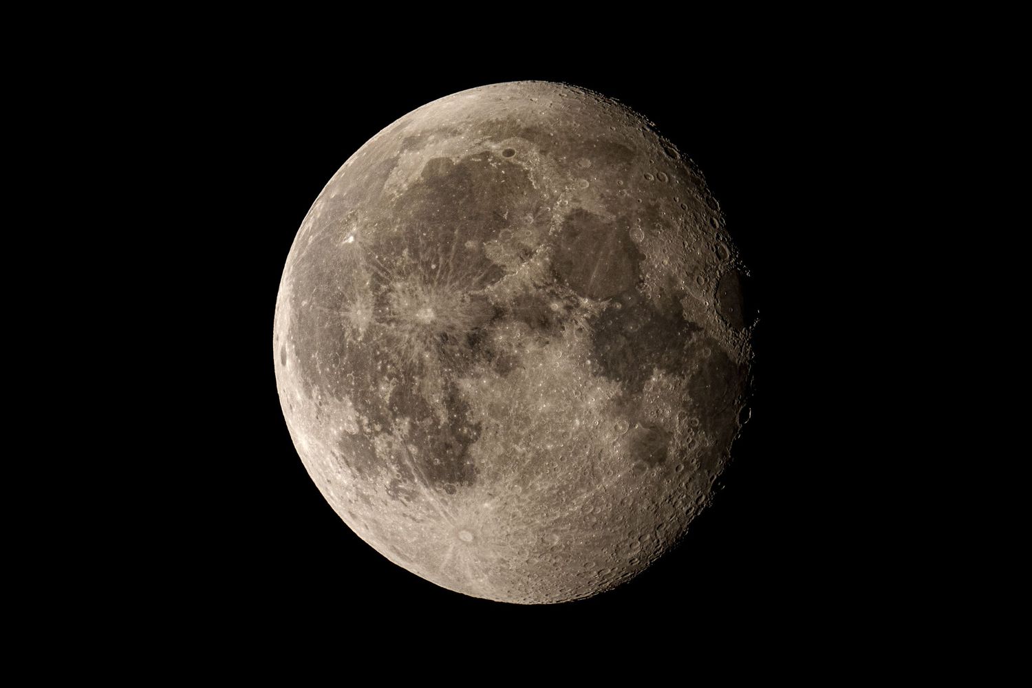 Detailed close-up photograph of a waning gibbous moon against a black night sky.