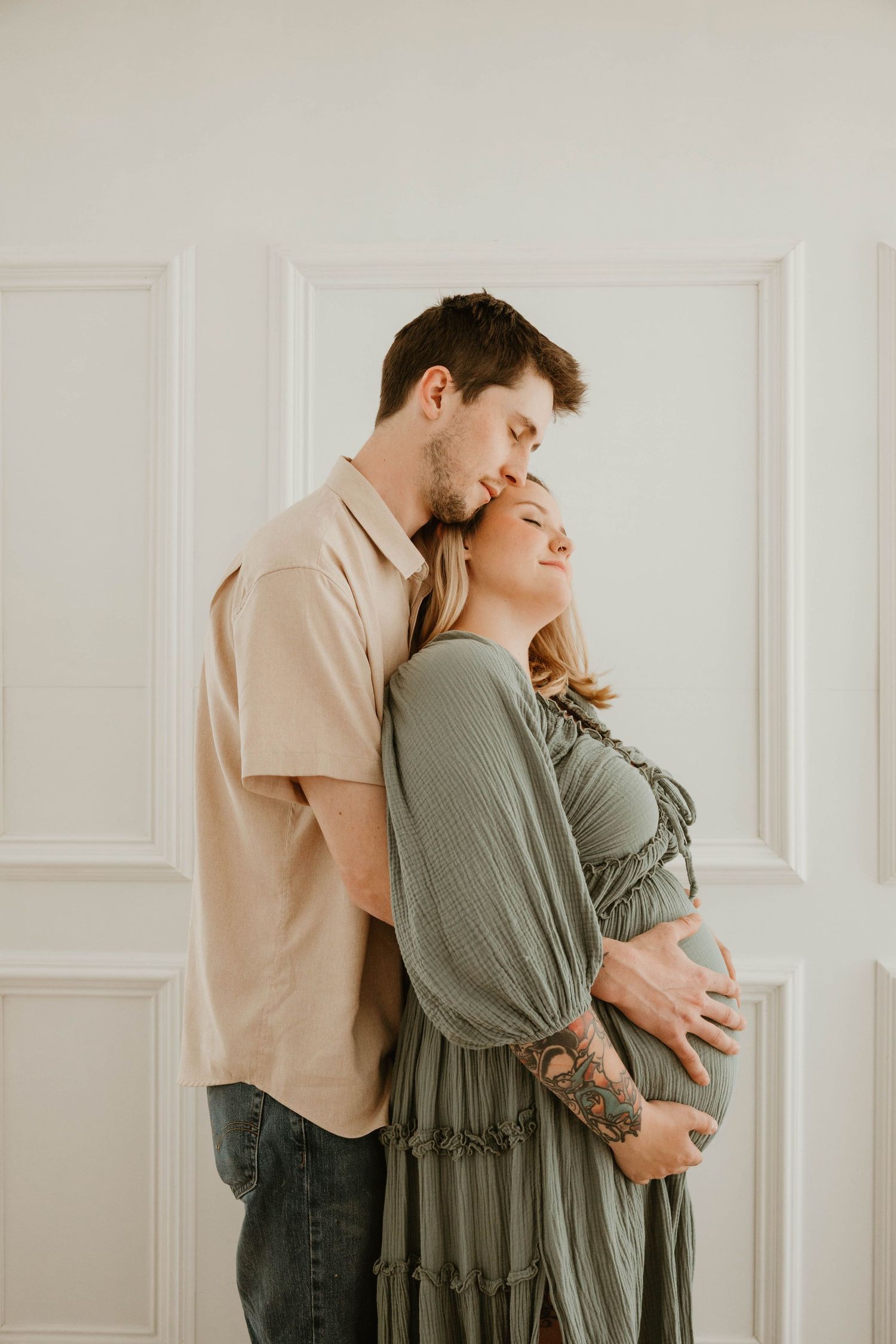 The image depicts a couple embracing, with the woman resting her head on the man's shoulder while he holds her close.