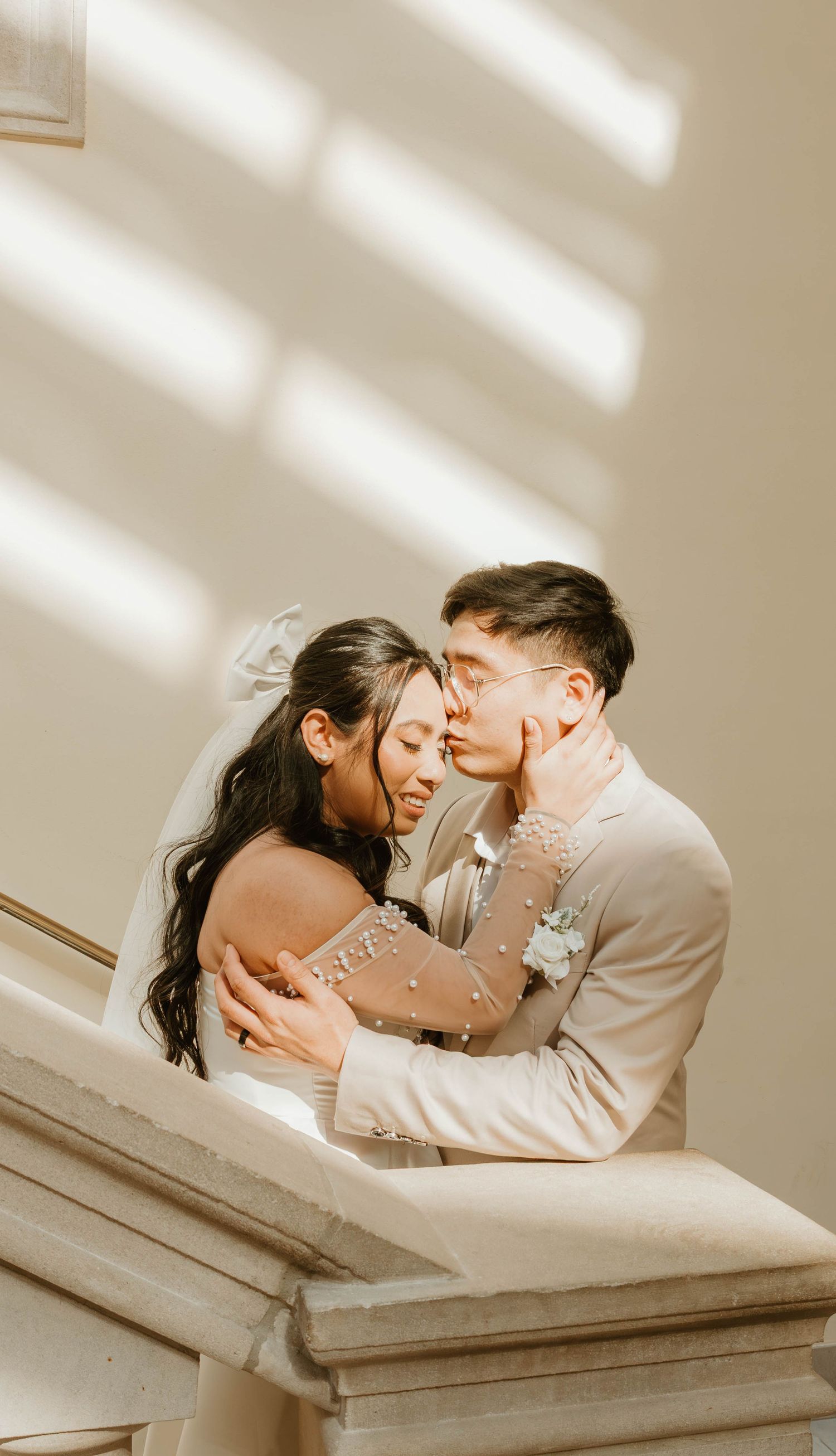 The image depicts a couple embracing on a staircase, with the woman leaning into the man.