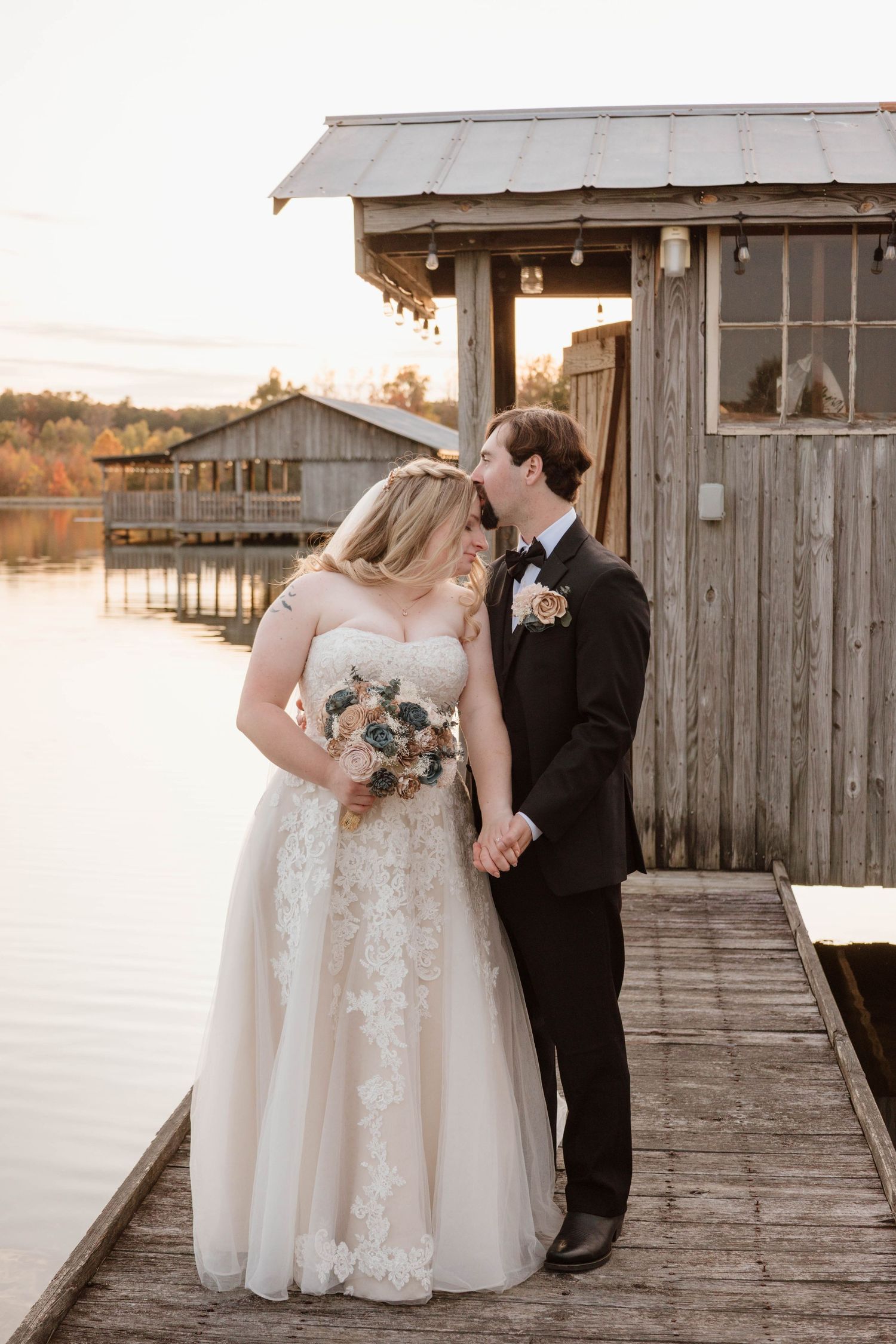 A romantic wedding photo session on a rustic wooden dock during sunset.