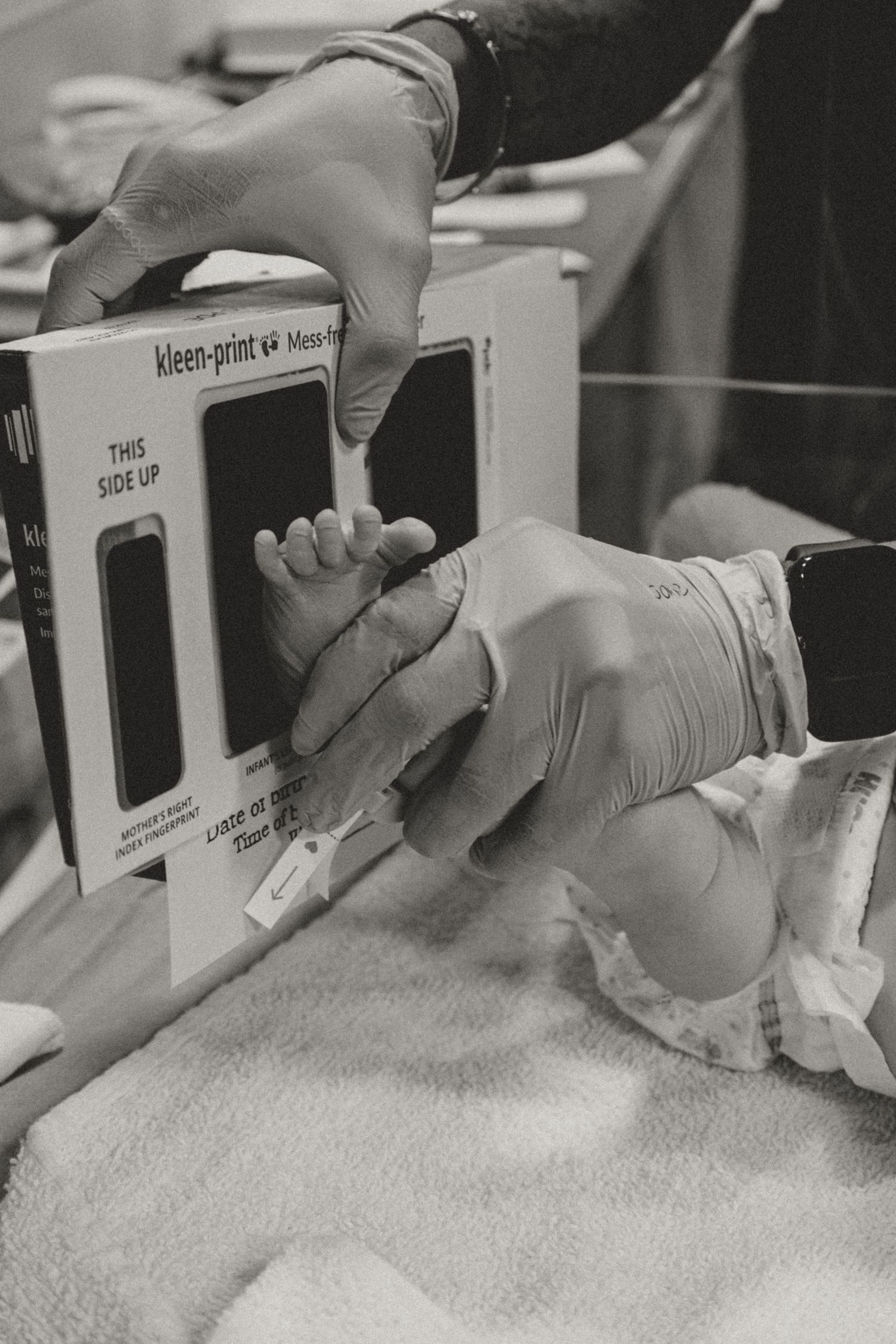 Close-up of hands scanning a barcode with medical equipment.