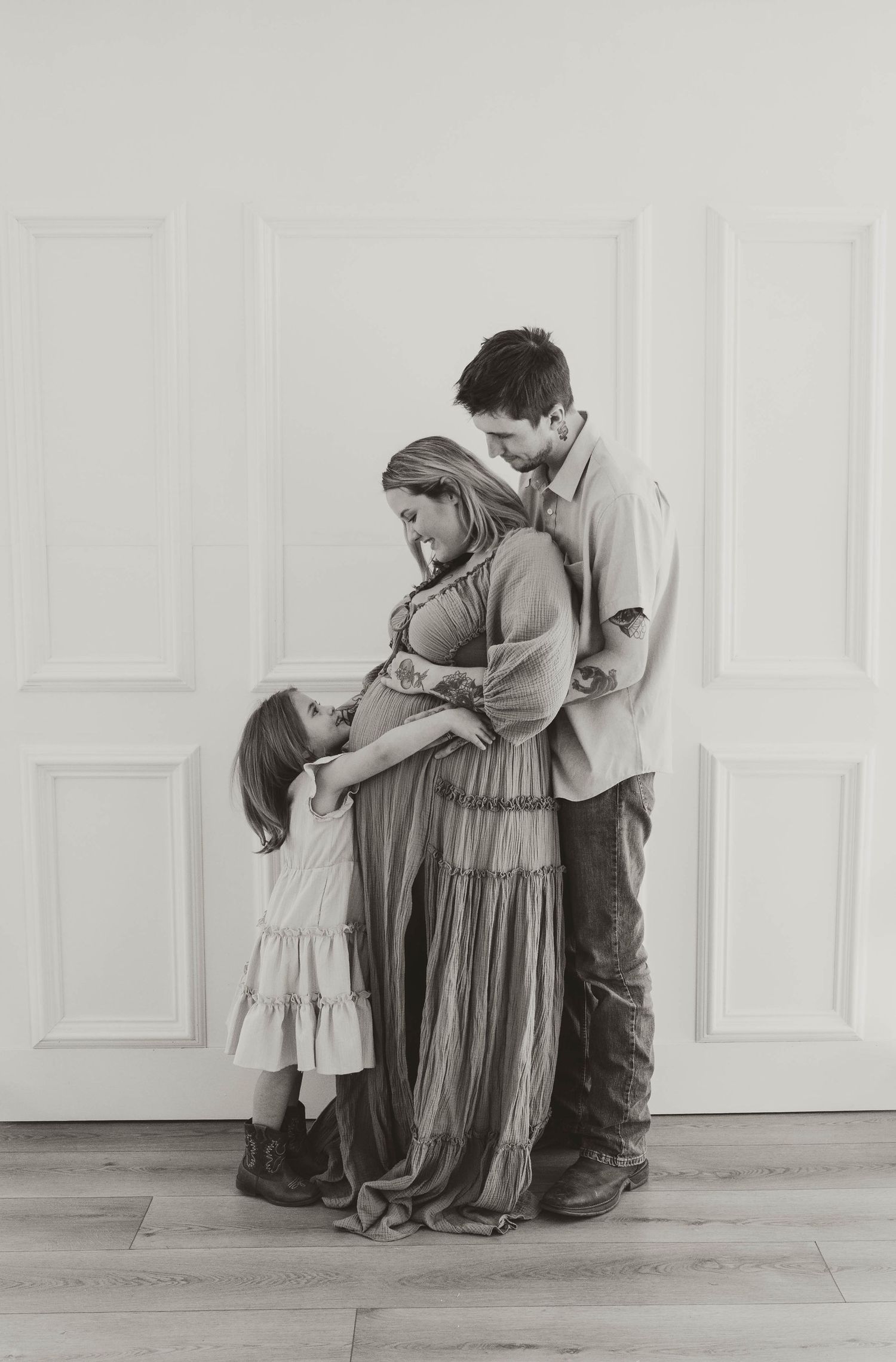 A black and white photograph showing a couple embracing in a romantic pose.