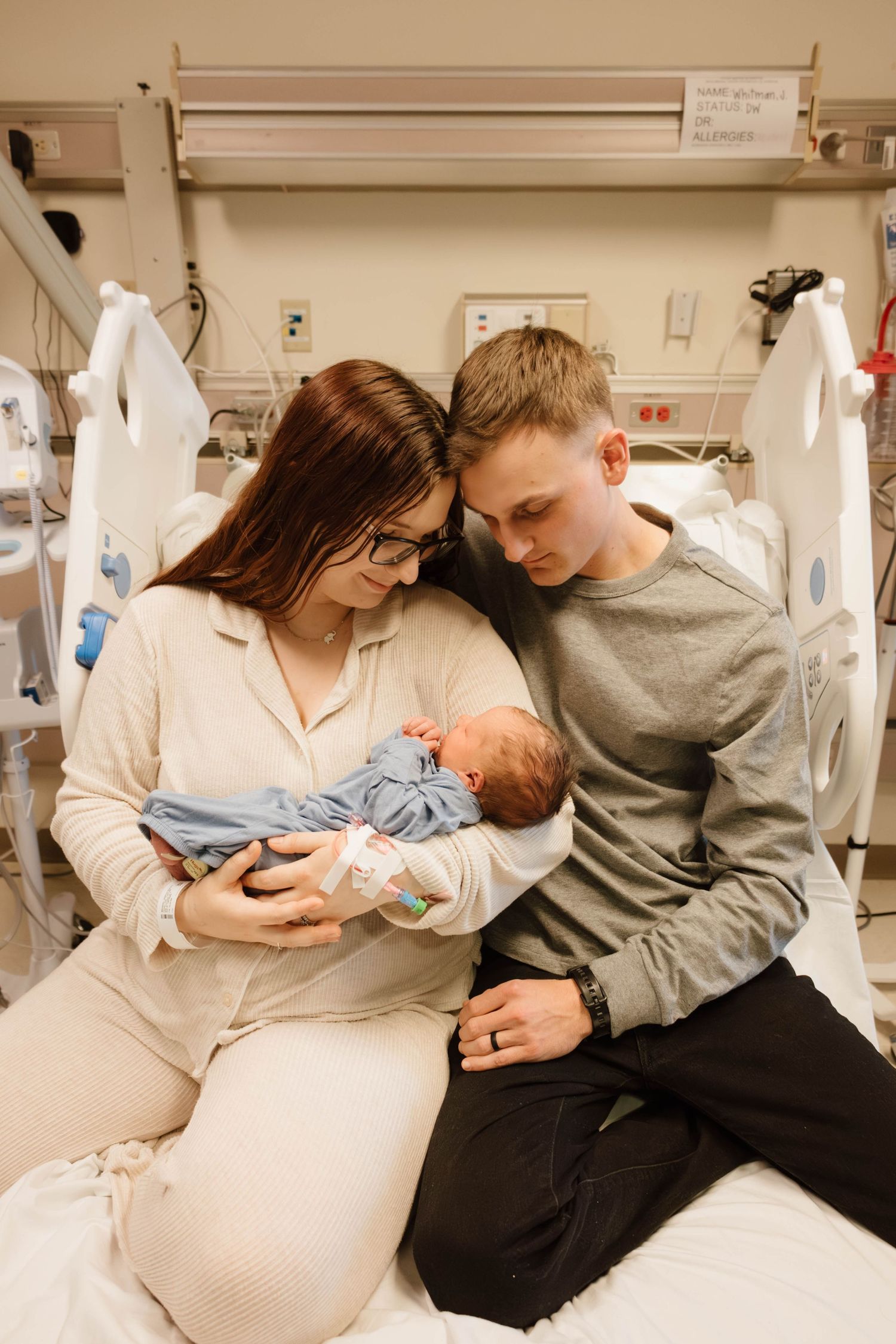 A couple shares tender moments in a hospital room as they welcome their newborn baby.