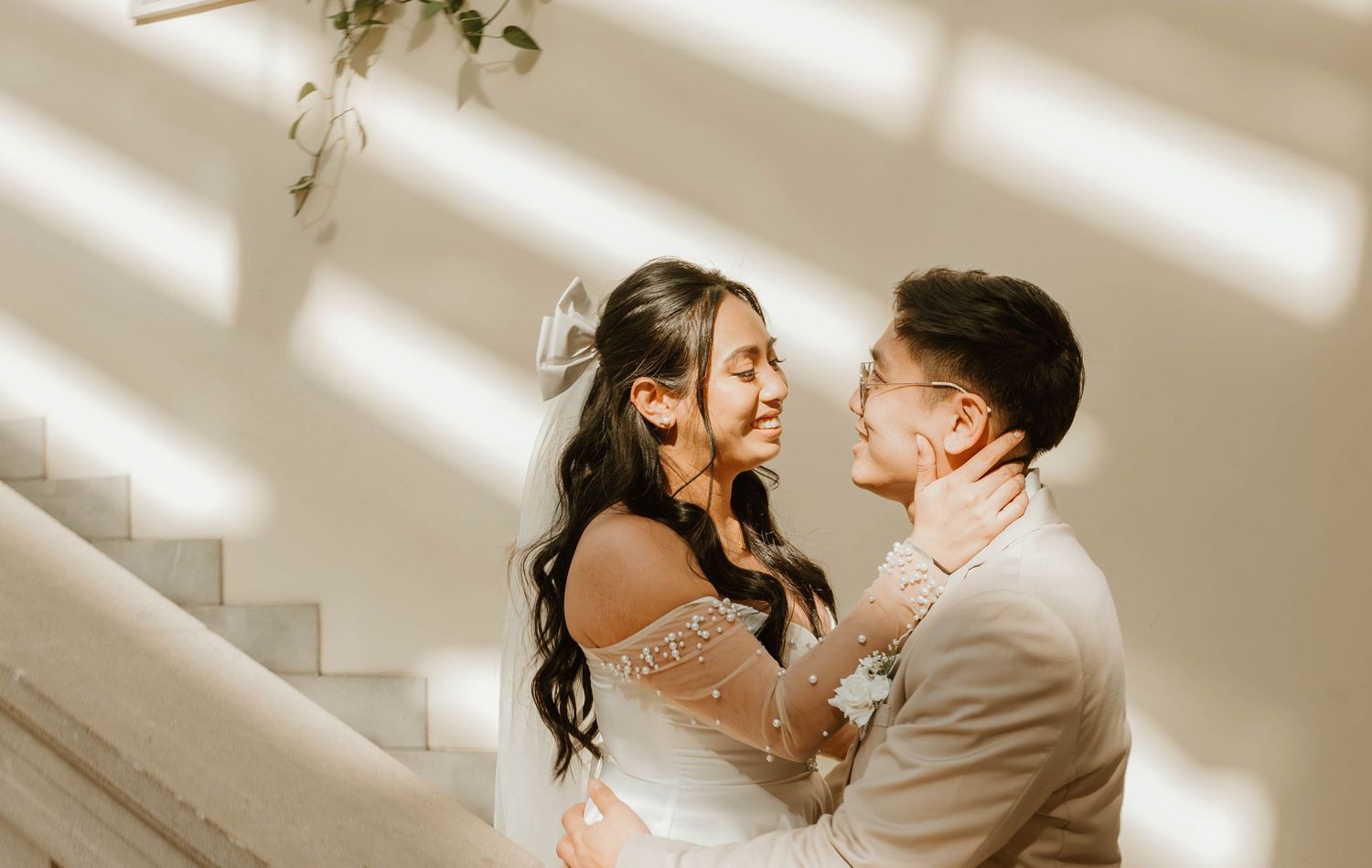 A bride and groom embrace and look at each other lovingly on their wedding day.