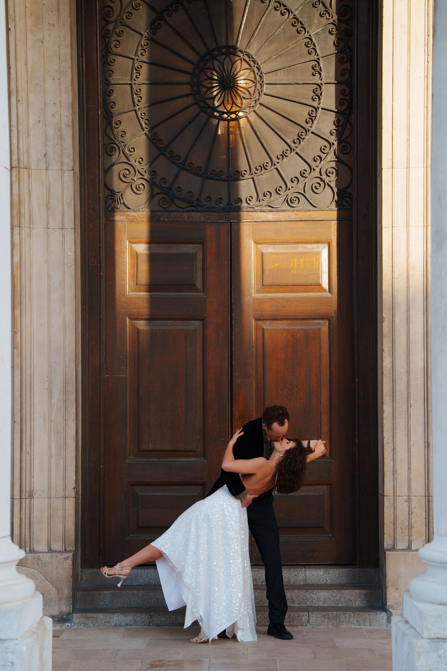 A series of dramatic dance poses between classical columns with ornate architectural details.