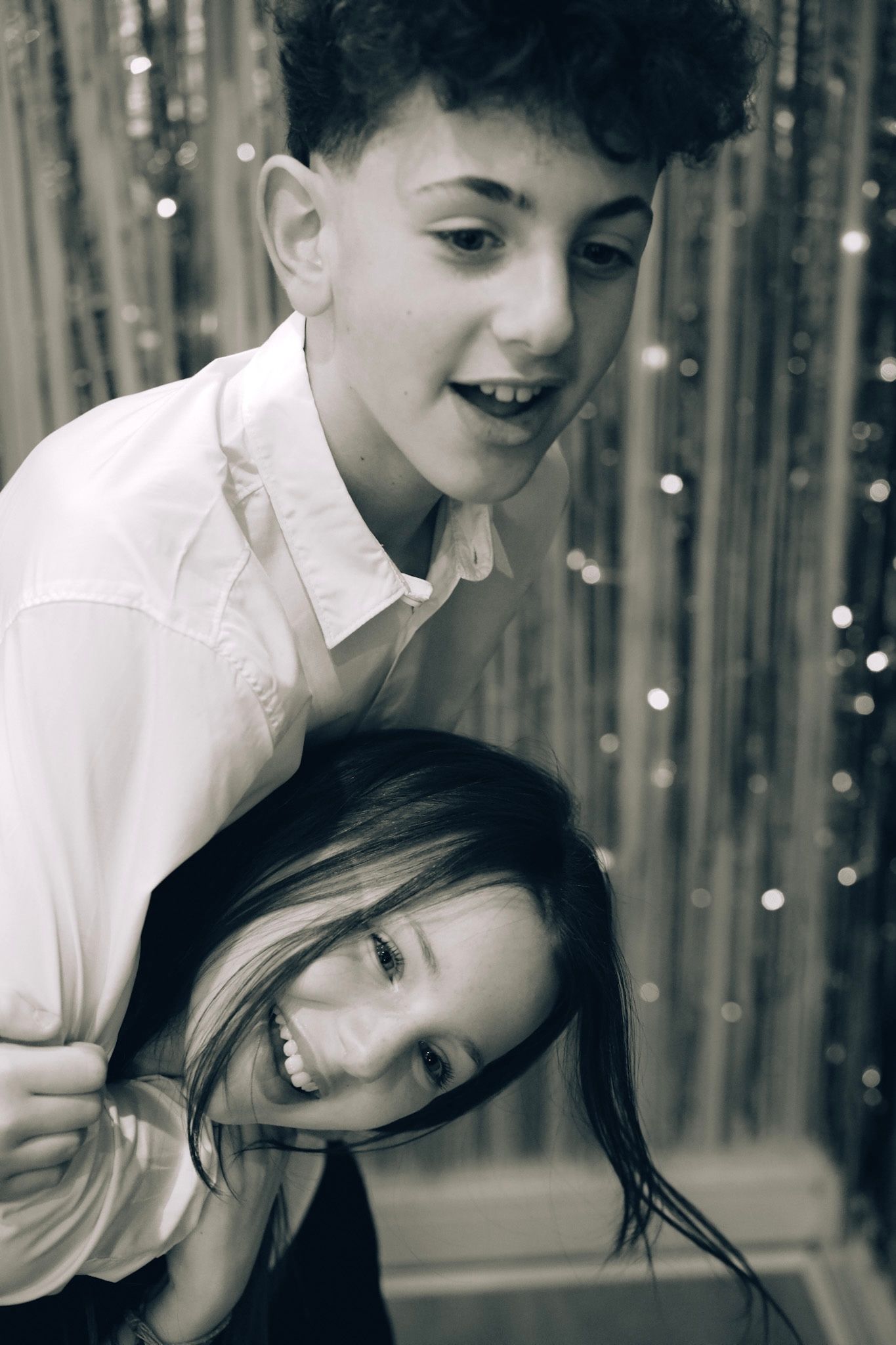 Two people sharing intimate moments against a sparkly backdrop.