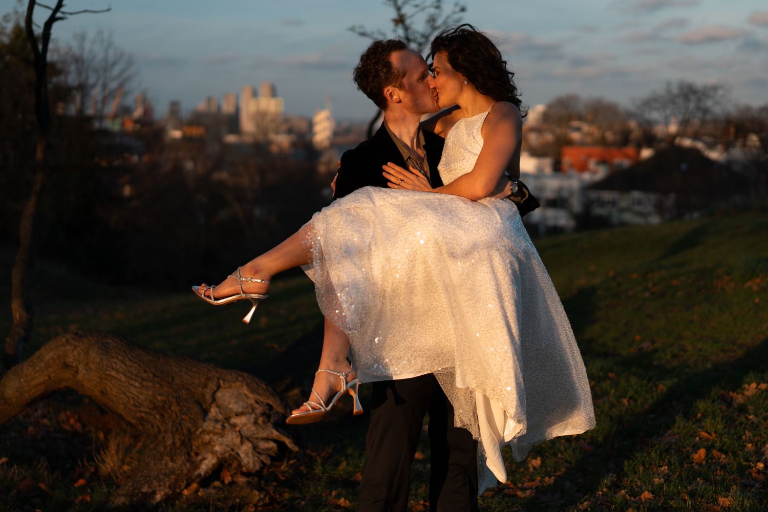 A romantic scene with a cityscape backdrop at dusk.