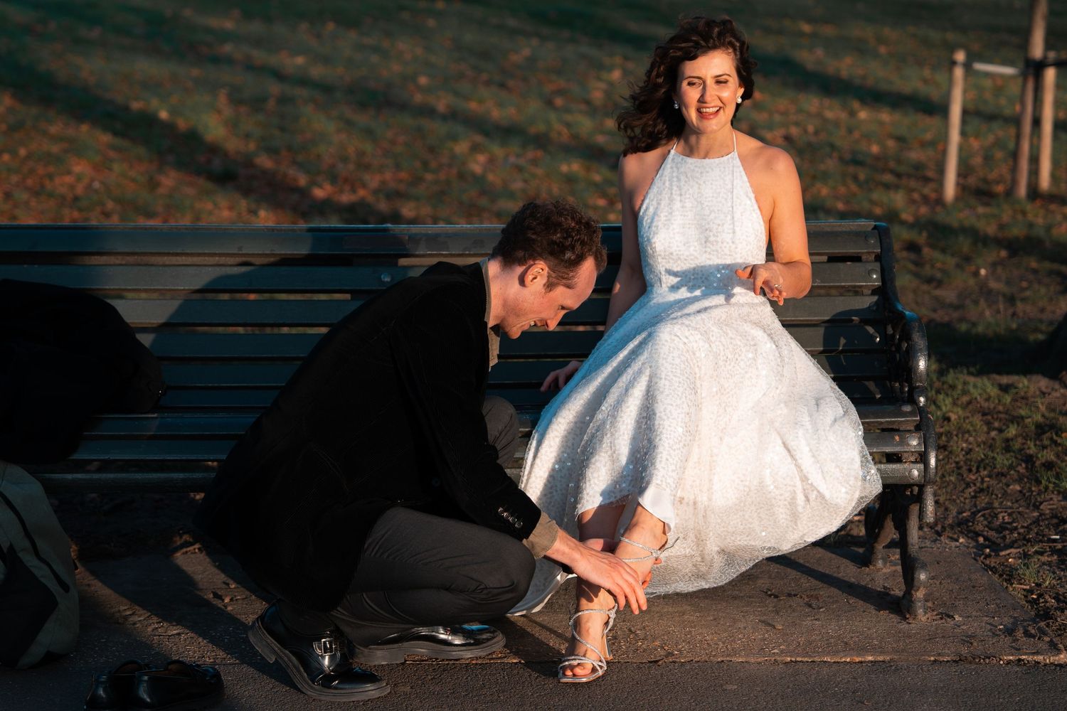 Creative photography session showing details of a flowing white dress outdoors.