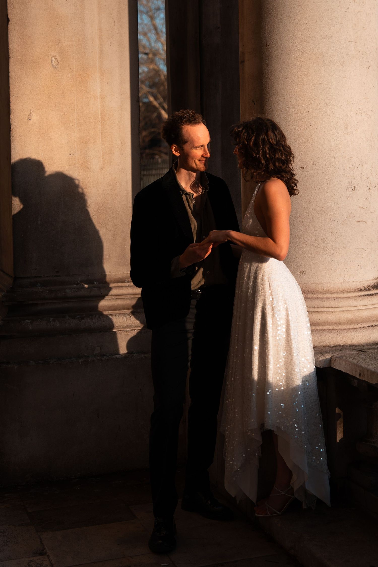 Intimate dance sequence photographed in the dramatic shadows of historic architecture.