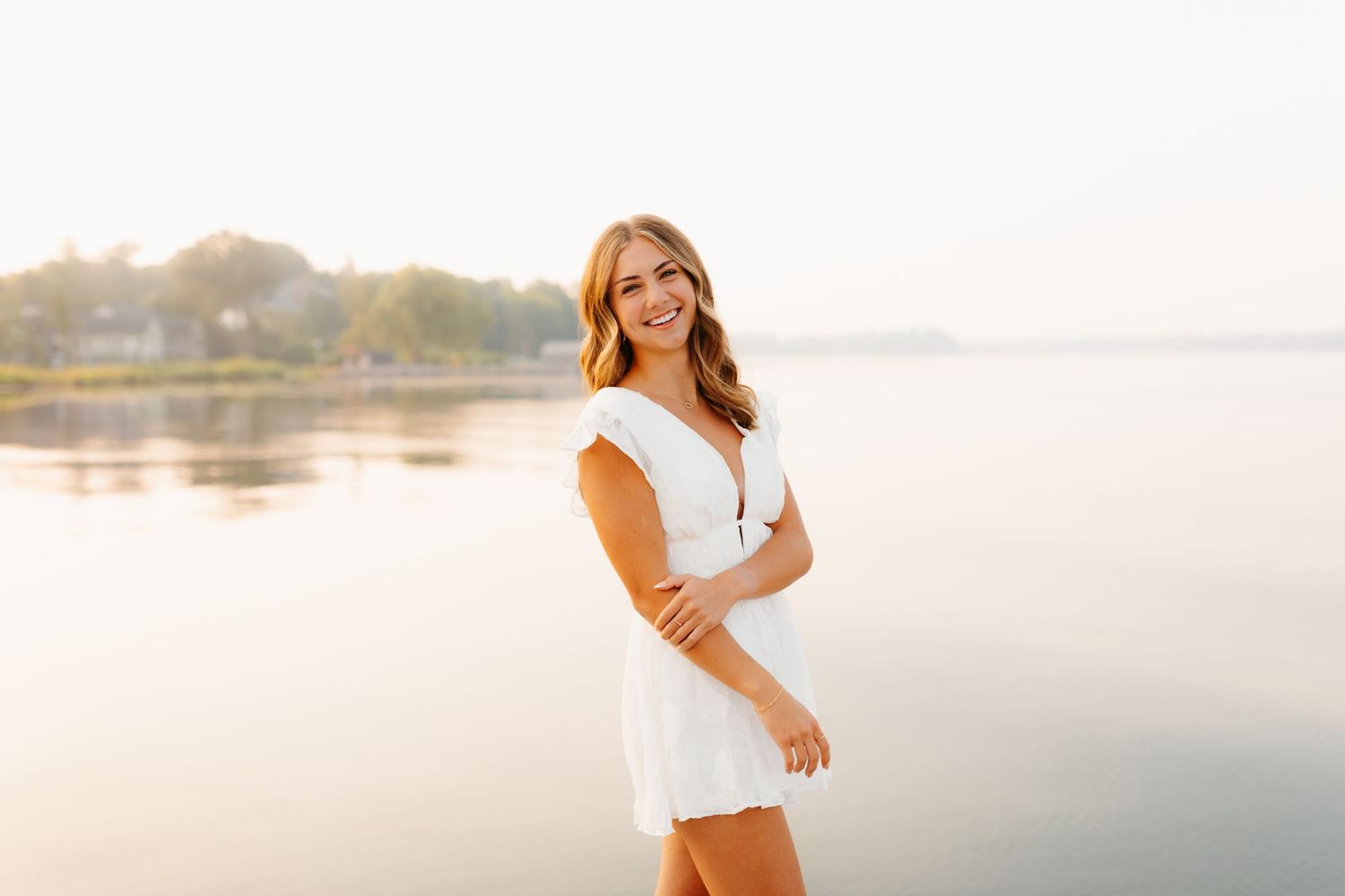 Casual summer portraits by a serene lakeside at sunset.