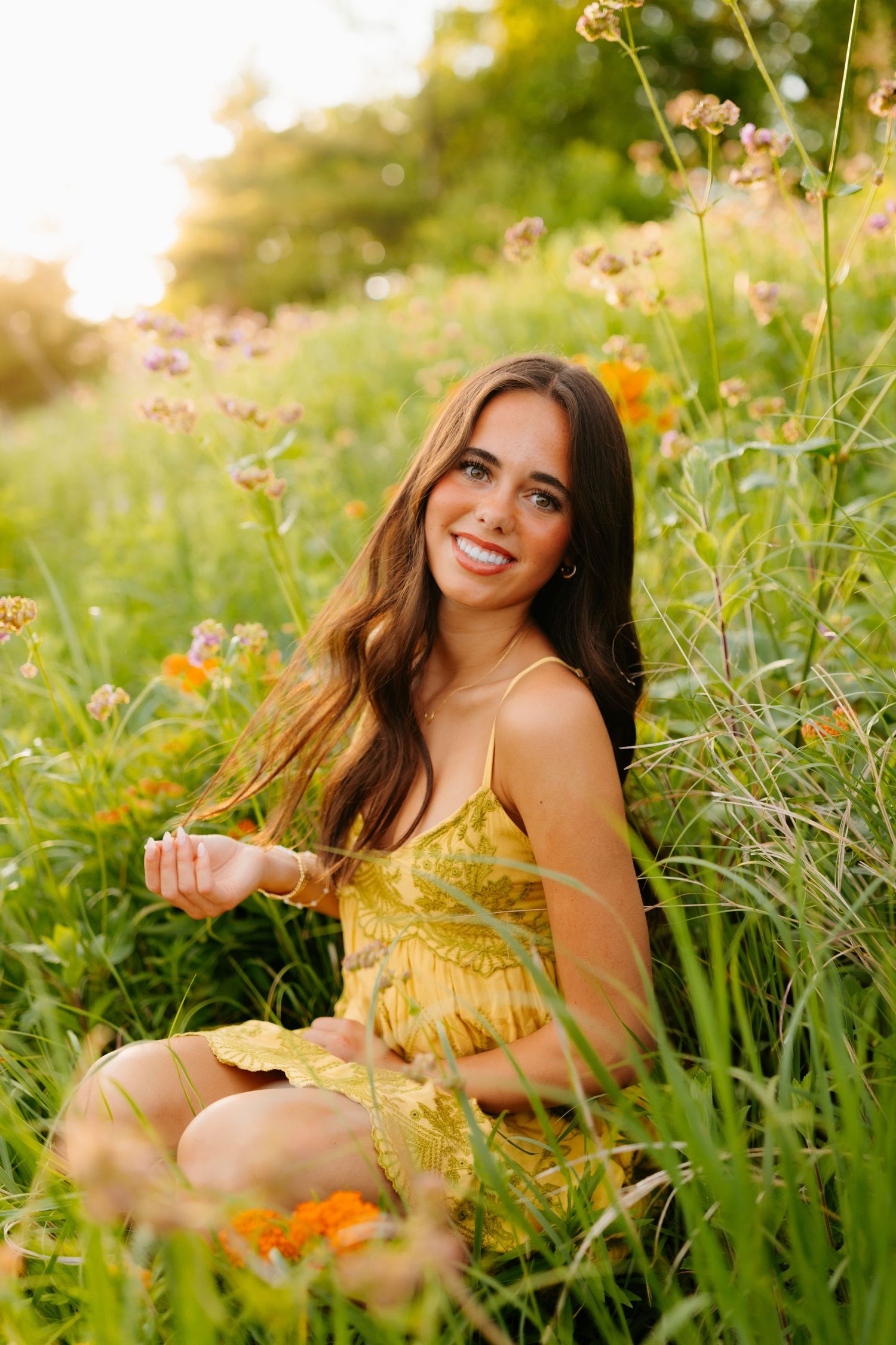 A yellow sundress glows in a golden-lit wildflower meadow during sunset.