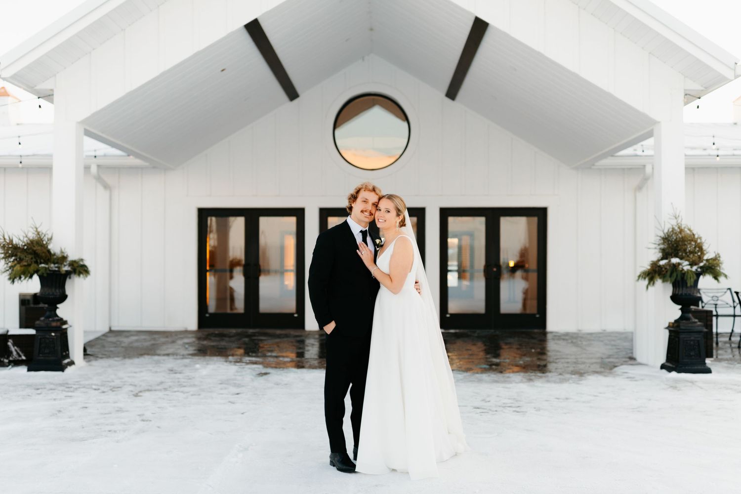 Modern white chapel exterior with clean architectural lines and black accents.