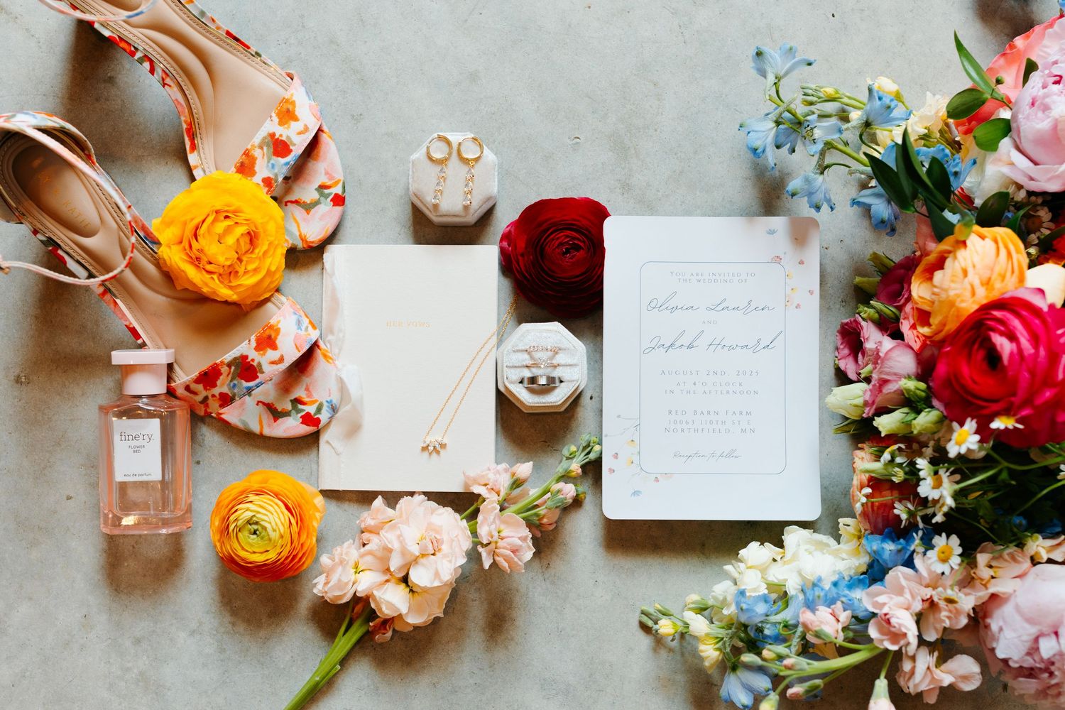 Wedding details flatlay with flowers, perfume, invitation and bridal shoes in soft pastel colors.