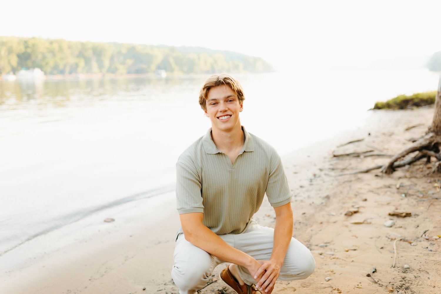 Casual beach portrait session on a rocky shoreline at sunset.