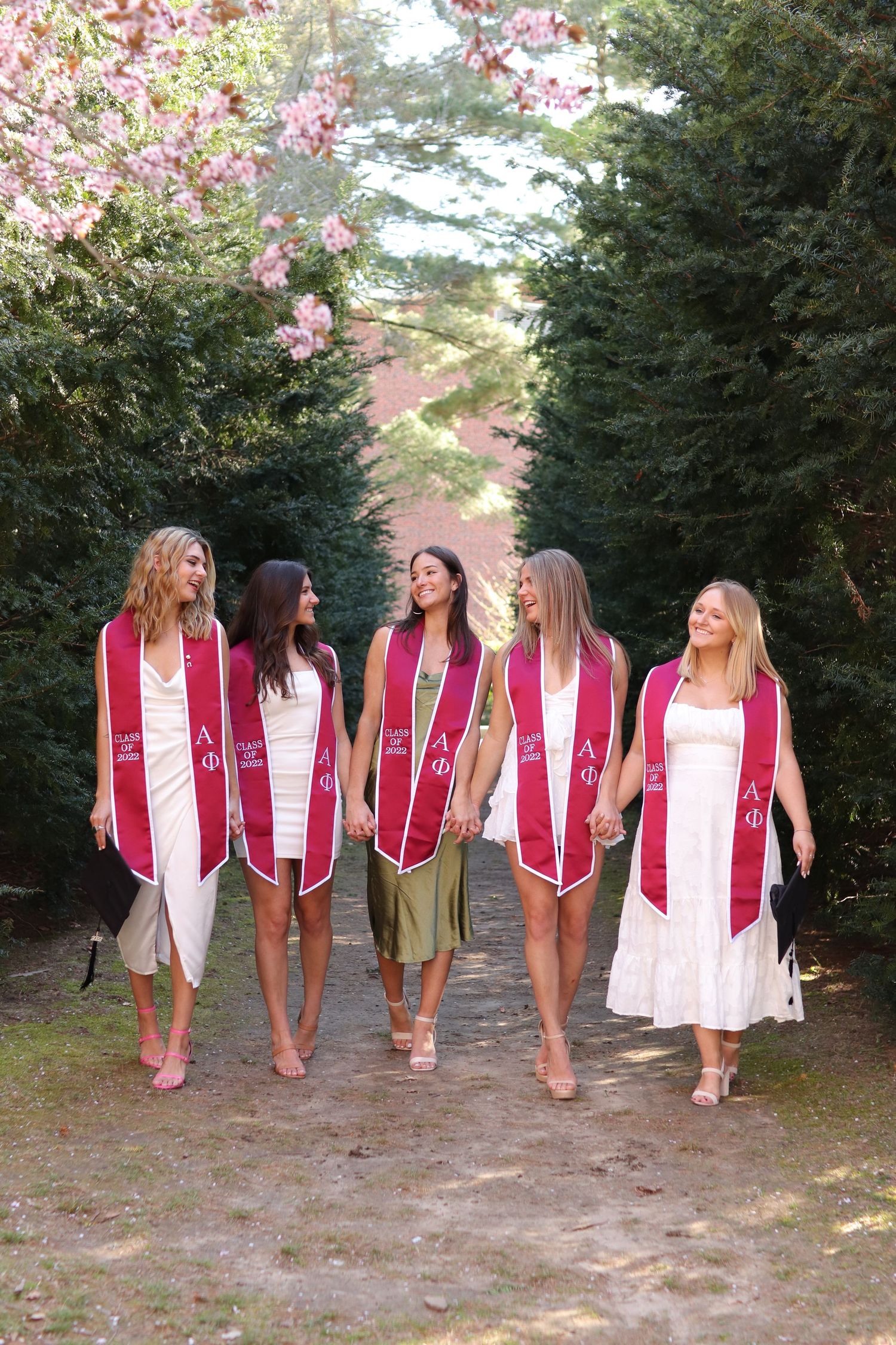 College friends graduation photos, natural lighting photography, WPI, sorority, senior grad photos. Worcester, MA. Walking towards camera.